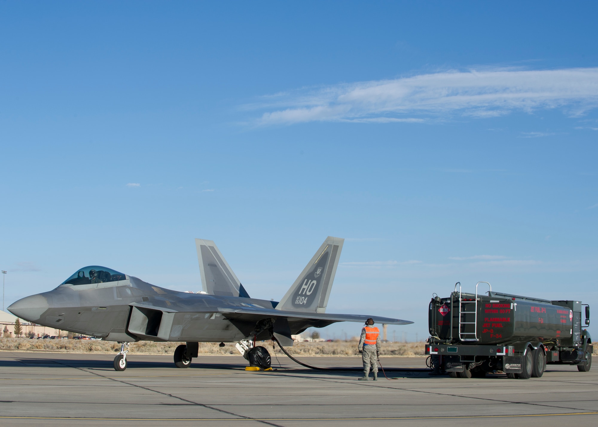 HOLLOMAN AIR FORCE BASE, N.M. -- An F-22 is being refueled by petroleum, oil and lubricants technicians during a hot pit operation Feb. 13. POL technicians with the 49th Logistics Readiness Squadron are responsible for all fuel on the installation. (U.S. Air Force photo by Airman 1st Michael Shoemaker/Released)
