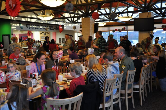 Members of Team Beale enjoy dinner during the Hearts Apart dinner at the Contrails Dining Facility at Beale Air Force Base, Calif., Feb. 15, 2012. The event featured a buffet style dinner, children’s games, raffle, and live music by the U.S. Air Force Band of the Golden West.    
