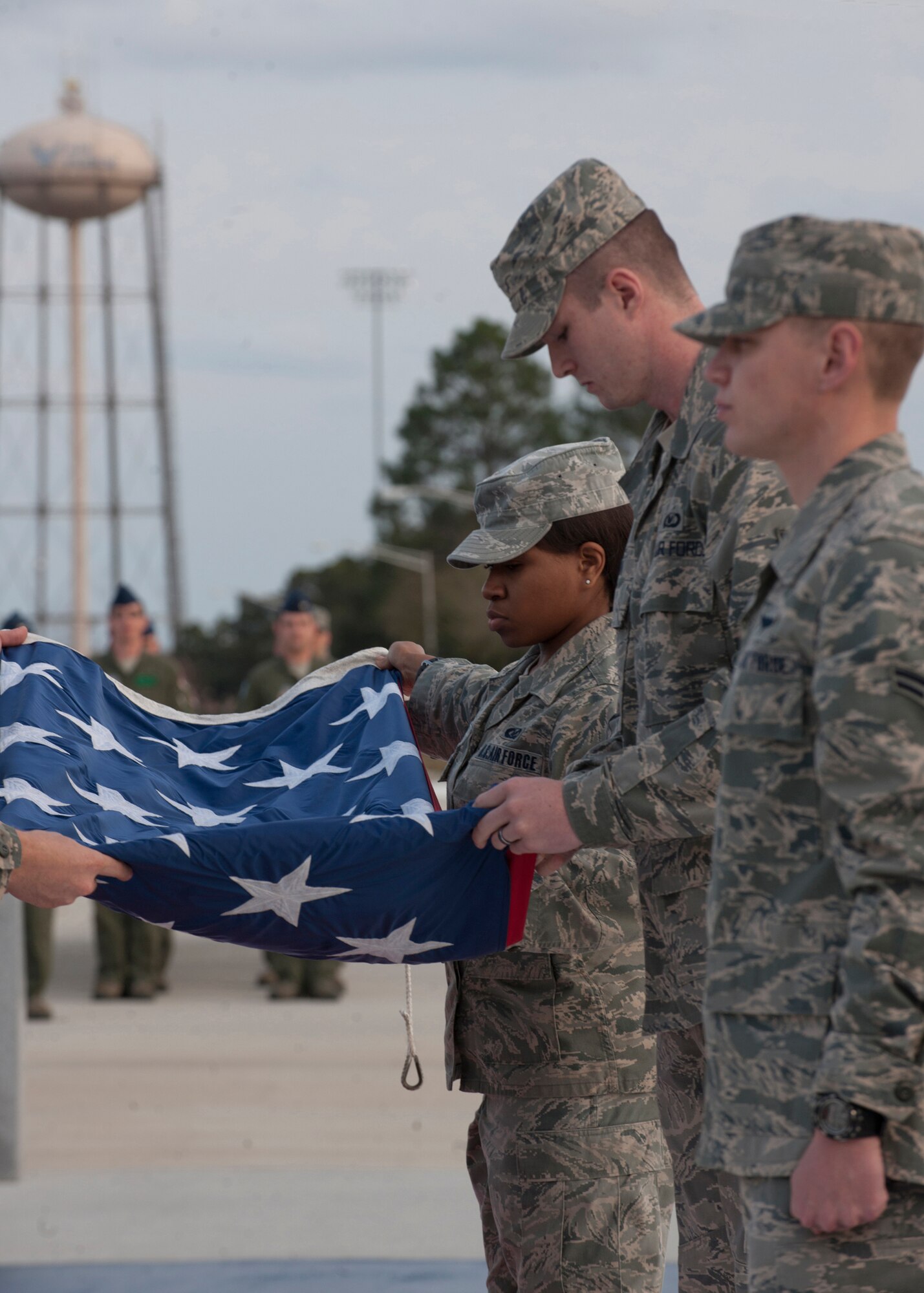 Airmen with the 347th Rescue Group pay tribute to the flag by conducting the retreat ceremony at the President George W. Bush Air Park at Moody Field Feb. 21, 2012 at Moody Air Force Base, Ga. The retreat ceremony signals the end of the official duty day and has been a tradition since the Revolutionary War. (U.S. Air Force photo by Senior Airman Eileen Meier/Released)