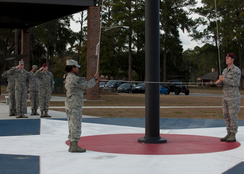 Airmen from the 347th Rescue Group lower the flag during a retreat ceremony at the President George W. Bush Air Park at Moody Field Feb. 21, 2012, at Moody Air Force Base, Ga. The ceremony will be conducted every month by a different group of the 23d Wing to pay respect to the flag. (U.S. Air Force photo by Senior Airman Eileen Meier/Released)