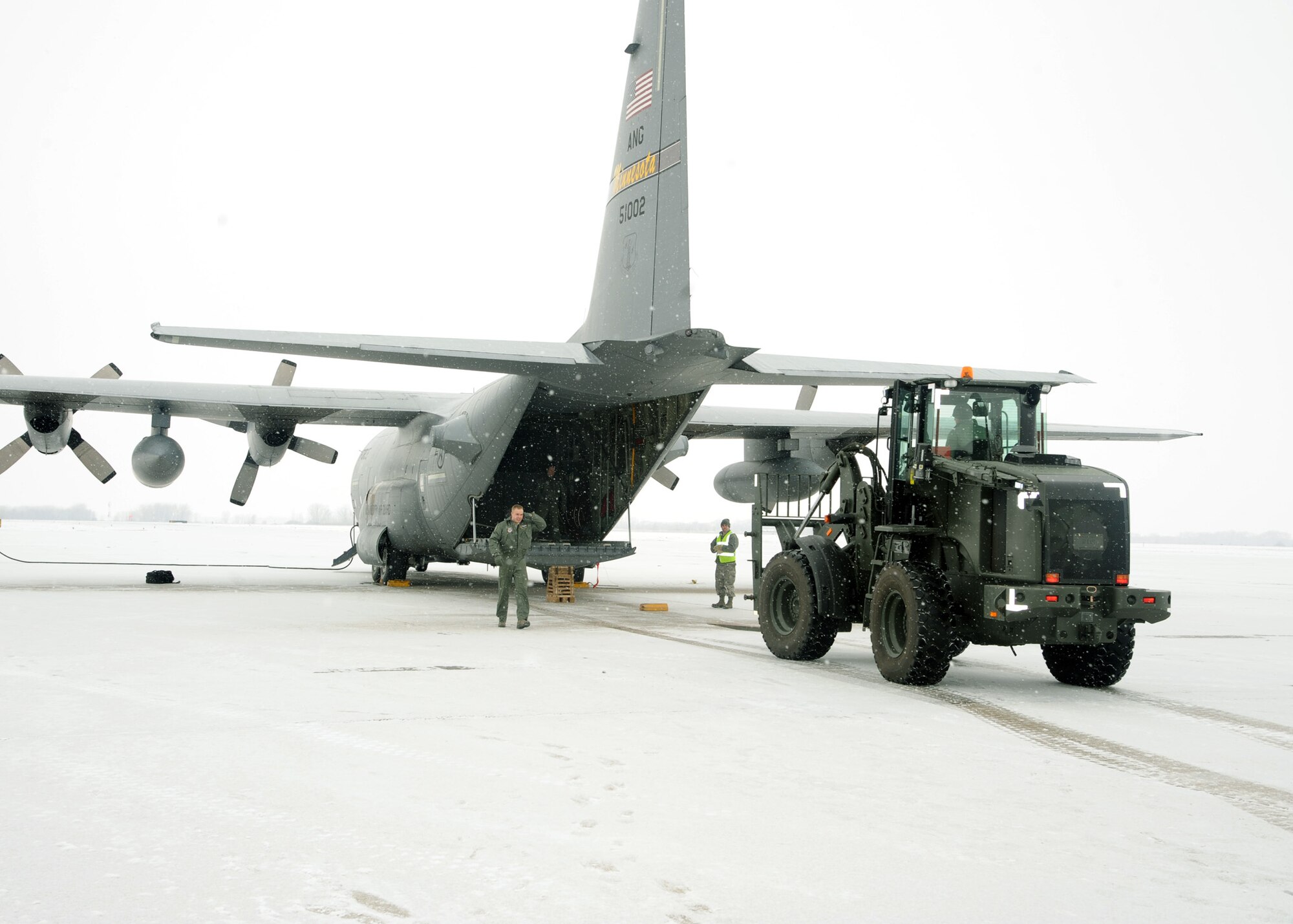 A fork lift from the 319th Logistics Readiness Squadron loads the final cargo item onto a C-130 Hercules during a live cargo load training conducted Feb. 22, 2012, on Grand Forks Air Force Base, N.D.  The purpose of the training was to help Airmen develop their skills and gain more experience on correctly loading and unloading cargo on and off live aircraft. (U.S. Air Force photo/Senior Airman Amber Bennett)  