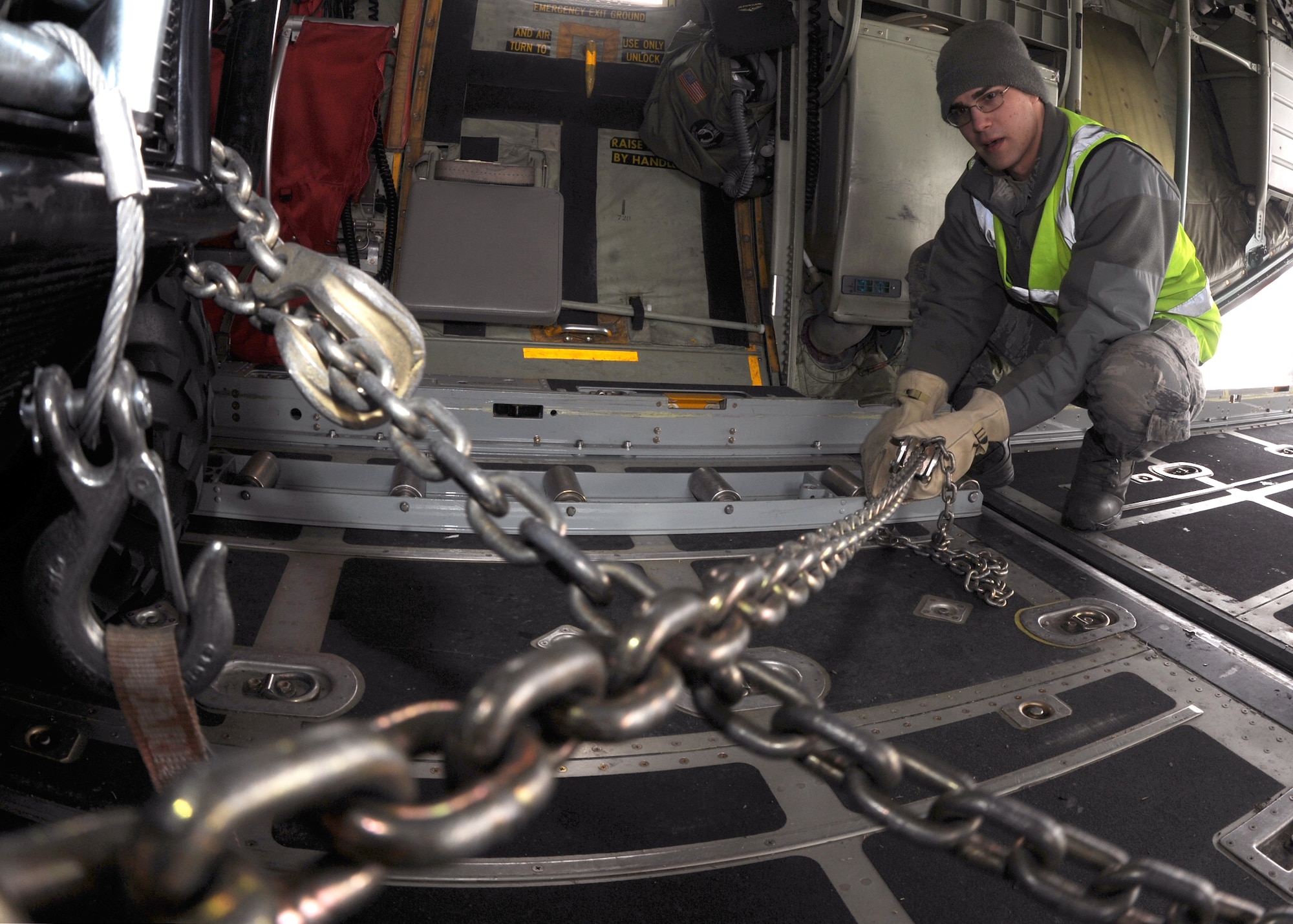 Airman 1st Class Will D’amico, 319th Logistics Readiness Squadron, fastens an all terrain vehicle during loadmaster training aboard a C-130 Hercules, which taxied at Grand Forks Air Force Base, N.D., Feb. 22, 2012.  The arrival of the aircraft allowed Airmen from the 319th Logistics Readiness Squadron to take part in training scenarios designed to help them develop their skills and gain more experience on correctly loading and unloading cargo on and off live aircraft. (U.S. Air Force photo/Airman 1st Class Xavier Navarro)