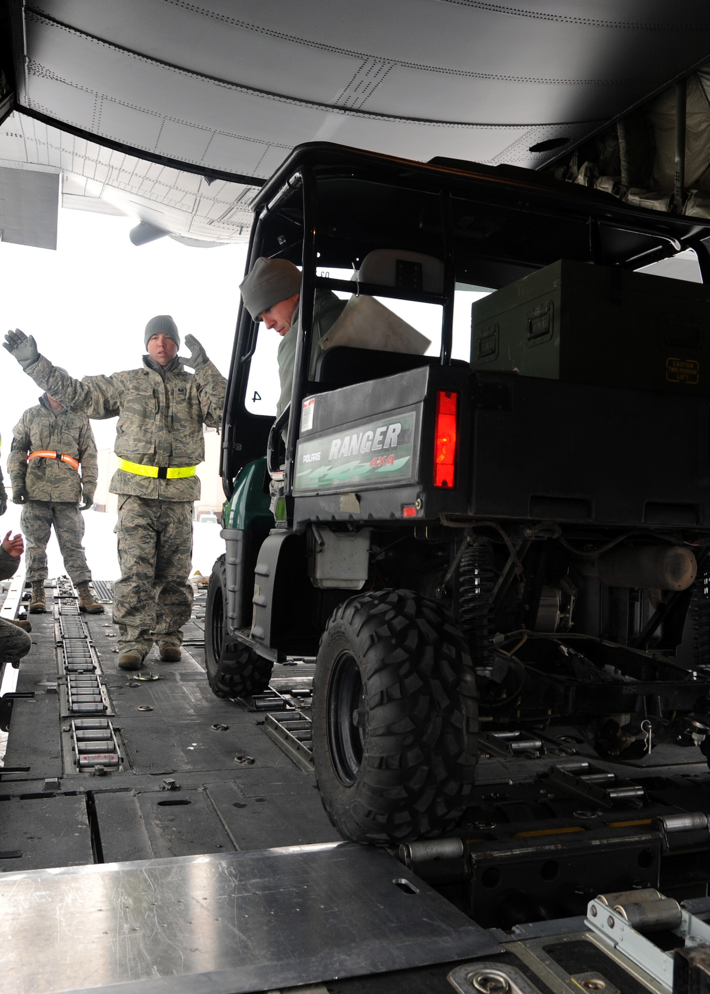 Tech. Sgt. Kevin Reiter, left, and Airman 1st Class Grant Gleason, members of 319th Logistics Readiness Squadron, load an all terrain vehicle into a C-130 Hercules after it touched down on the flight line on Grand Forks Air Force Base, N.D., Feb. 22, 2012. The arrival of the aircraft allowed Airmen from the 319th Logistics Readiness Squadron to take part in training scenarios designed to help them develop their skills and gain more experience on correctly loading and unloading cargo on and off live aircraft. (U.S. Air Force photo/Senior Airman Amber Bennett)