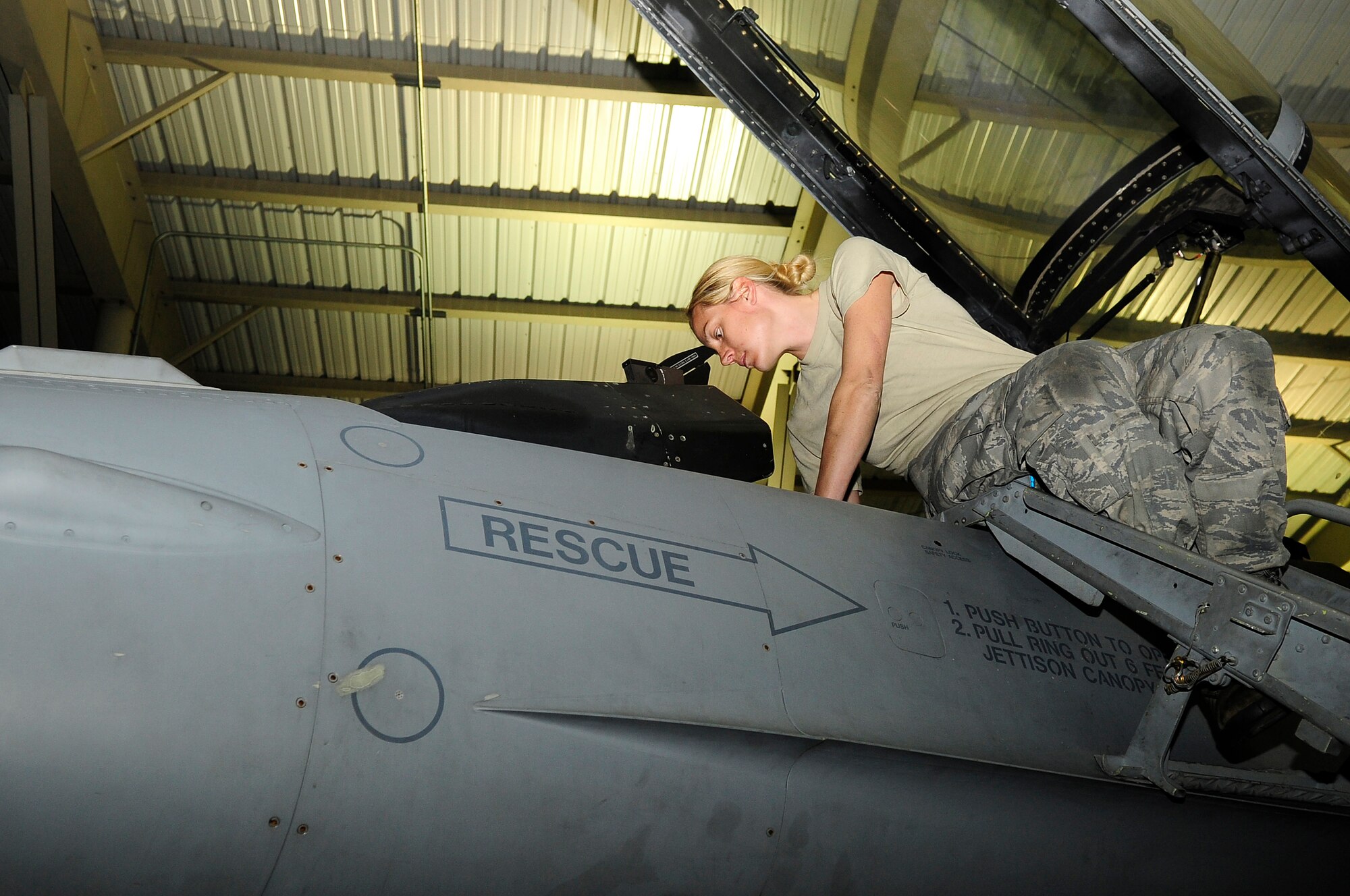 U.S. Air Force Senior Airman Tammy Thompson, 20th Aircraft Maintenance Squadron, climbs down from an F-16 Fighting Falcon after performing an operations check at Shaw Air Force Base, S.C., Feb. 23, 2012. The 20th AMXS Airmen work around the clock to ensure Shaw’s F-16 fleet is prepared for all training and real world missions.  (U.S. Air Force photo by Airman 1st Class Hunter Brady/Released)