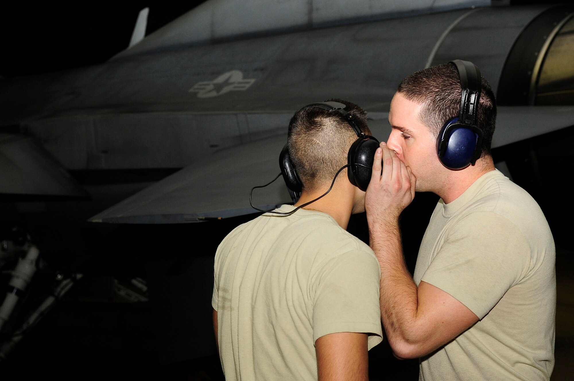 U.S. Air Force Senior Airman Aaron Simonson speaks to Senior Airman Kenneth Cordova, both 20th Aircraft Maintenance Squadron crew chiefs, during an operations check at Shaw Air Force Base, S.C., Feb. 23, 2012. The 20th AMXS Airmen work around the clock to ensure Shaw’s F-16 fleet is prepared for all training and real world missions. (U.S. Air Force photo by Airman 1st Class Hunter Brady/Released)