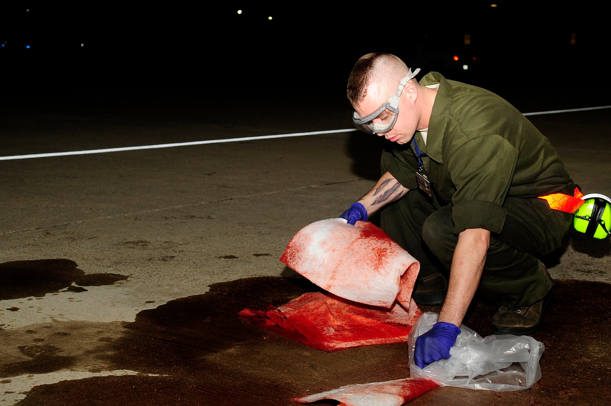U.S. Air Force Senior Airman Dominic Dizes, 20th Aircraft Maintenance Squadron crew chief, cleans hydraulic fluid off of the flightline at Shaw Air Force Base, S.C., Feb. 23, 2012. The 20th AMXS Airmen work around the clock to ensure Shaw’s F-16 fleet is prepared for all training and real world missions. (U.S. Air Force photo by Airman 1st Class Hunter Brady/Released)