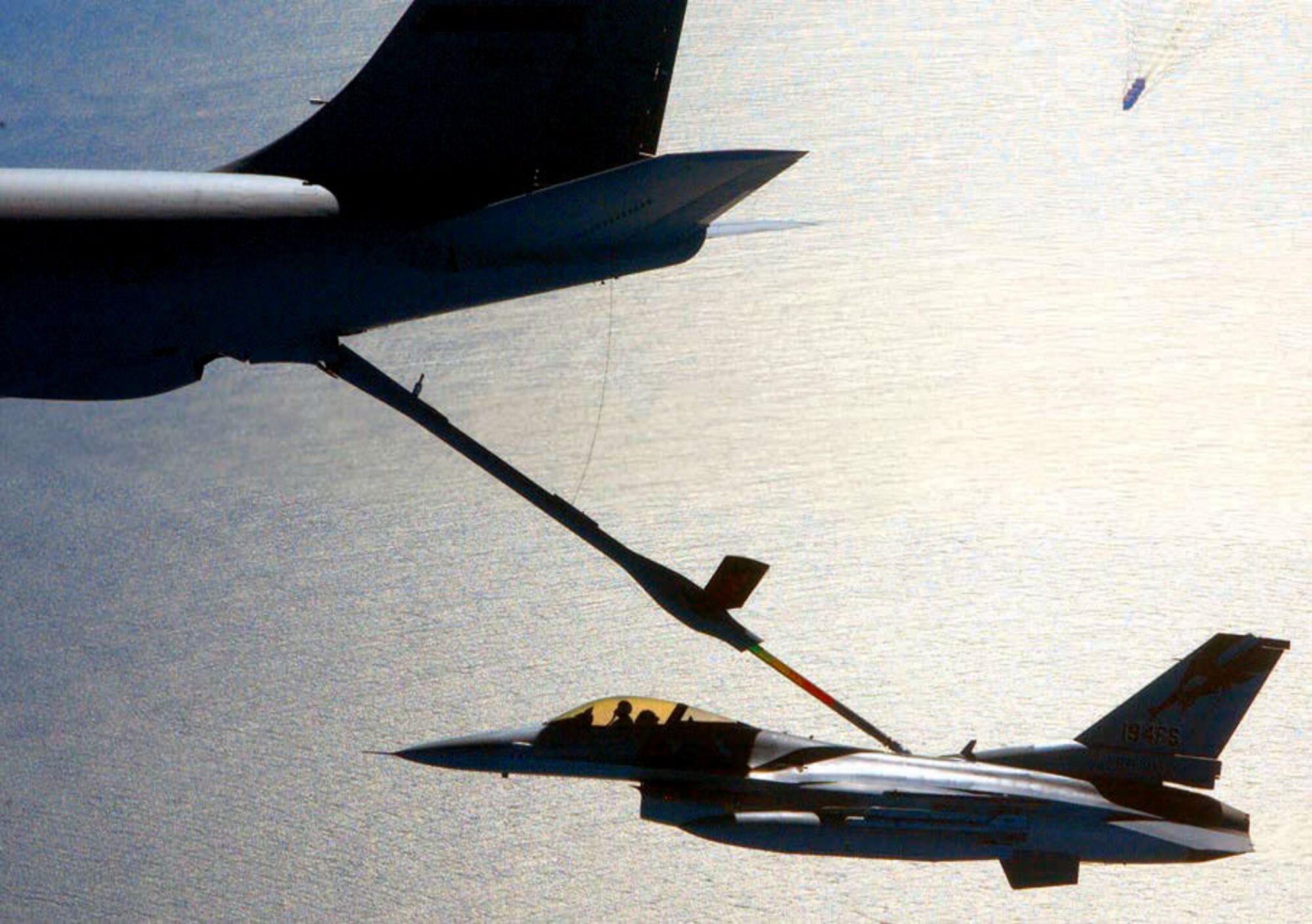 Major Rob Swertfager gets his F-16 Fighting Falcon refuled by a KC-135E Stratotanker during an Operation Noble Eagle training patrol March 16, 2004. Major Swertgager is a pilot with the California Air National Guard’s 144th Fighter Wing in Fresno, Calif. The KC-135E is assigned to the 940th Aerial Refueling Wing at Beale Air Force Base, Calif. (U.S. Air Force photo / Master Sgt. Lance Cheung)