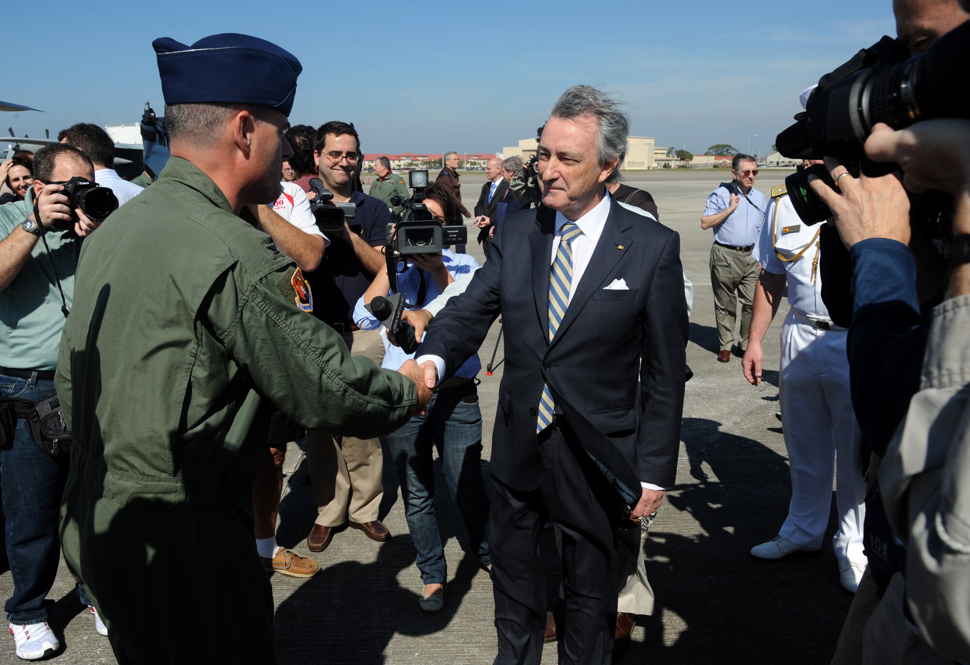 Col. Lenny Richoux, 6th Air Mobility Wing commander, shakes hands with the Spanish Ambassador to the United States, Jorge Dezcaller de Mazar, following a press conference regarding the coin transfer to the Spanish government, Feb. 24, 2012, on MacDill Air Force Base, Fla. The coins, which were lost at sea in the 19th century, were palletized and shipped back to Spain on two Spanish C-130 aircraft. (U. S. Air Force photo by Airman Basic David Tracy)