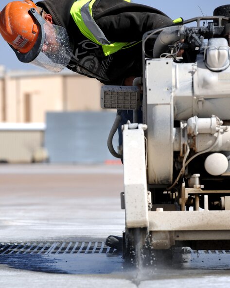 Mr. John Roberts repairs pavement on the flight line with a PS6585 Super Mag Concrete Saw Feb. 22, 2012, at Dyess Air Force Base, Texas. The taxi-way shoulder repair project is estimated to be finished March 12, 2012 and cost approximately $1.7 million. (U.S. Air Force photo by Airman 1st Class Jonathan Stefanko/ Released)