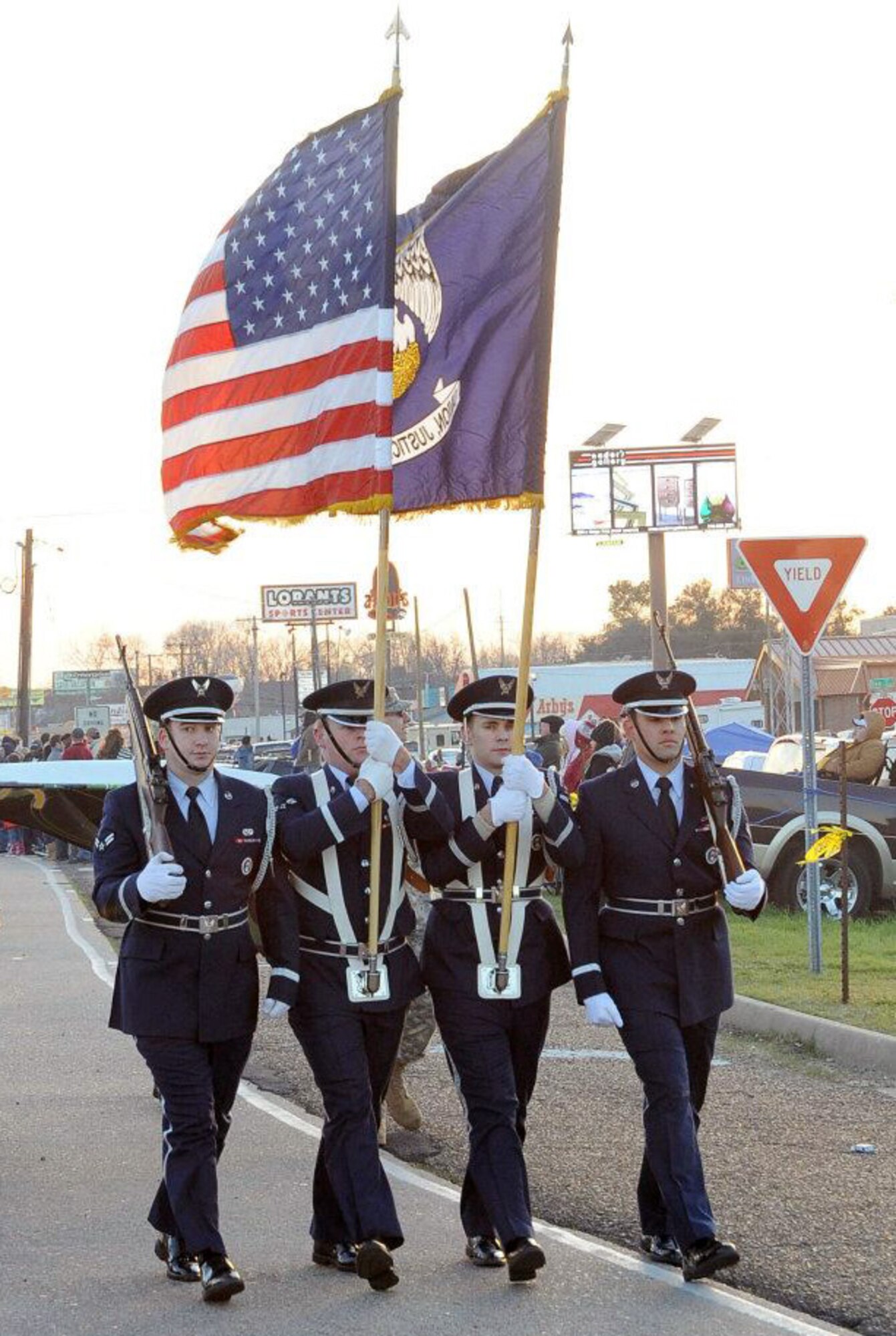 Barksdale Air Force Base Honor Guard members present the colors during the Krewe of Centaur Parade in Shreveport, La., Feb. 11. Thousands of local and base residents attended the parade to celebrate Mardi Gras. Barksdale Airmen also volunteered for the event, following alongside floats to keep the crowd a safe distance away. (U.S. Air Force photo/Senior Airman Amber Ashcraft)(RELEASED)