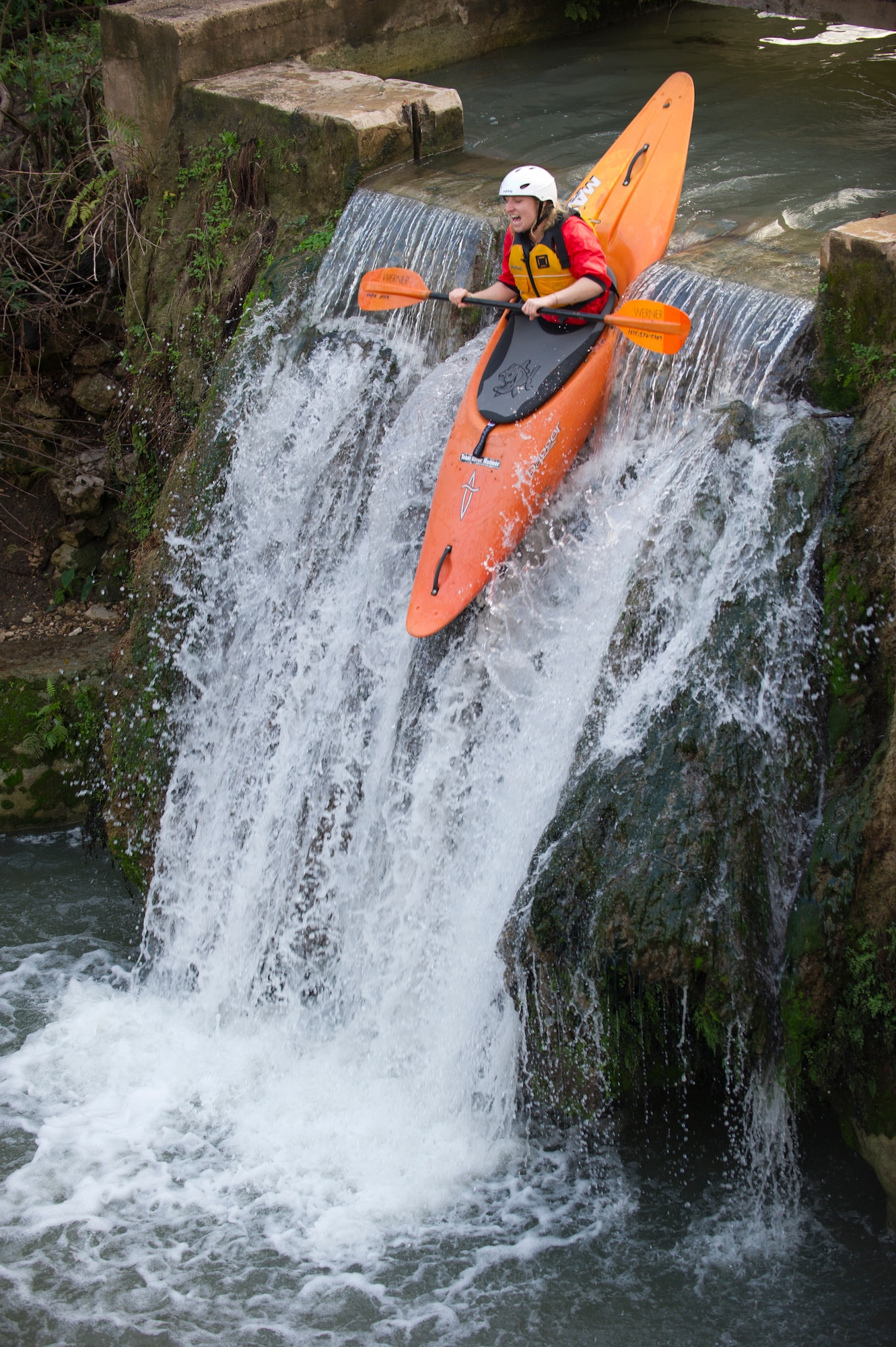 SAN MARCOS, Texas –- U.S. Air Force Airman 1st Class Mari Mosteller, 49th Wing public affairs, launches her boat off of a 15-foot waterfall here Feb. 19.  Learning how to manage the stress and anxiety of launching a boat off of a 15-foot waterfall helped Airmen a spouse and a civilian participating in the Holloman Outdoor Wingman Program to understand the manageability of stress in everyday life situations. Each Airman, spouse and civilian walked away with a better understanding of both how to handle themselves on a waterfall and how to cope through the stress of work in a healthy way. (U.S. Air Force photo by Airman 1st Class Daniel E. Liddicoet/Released)

