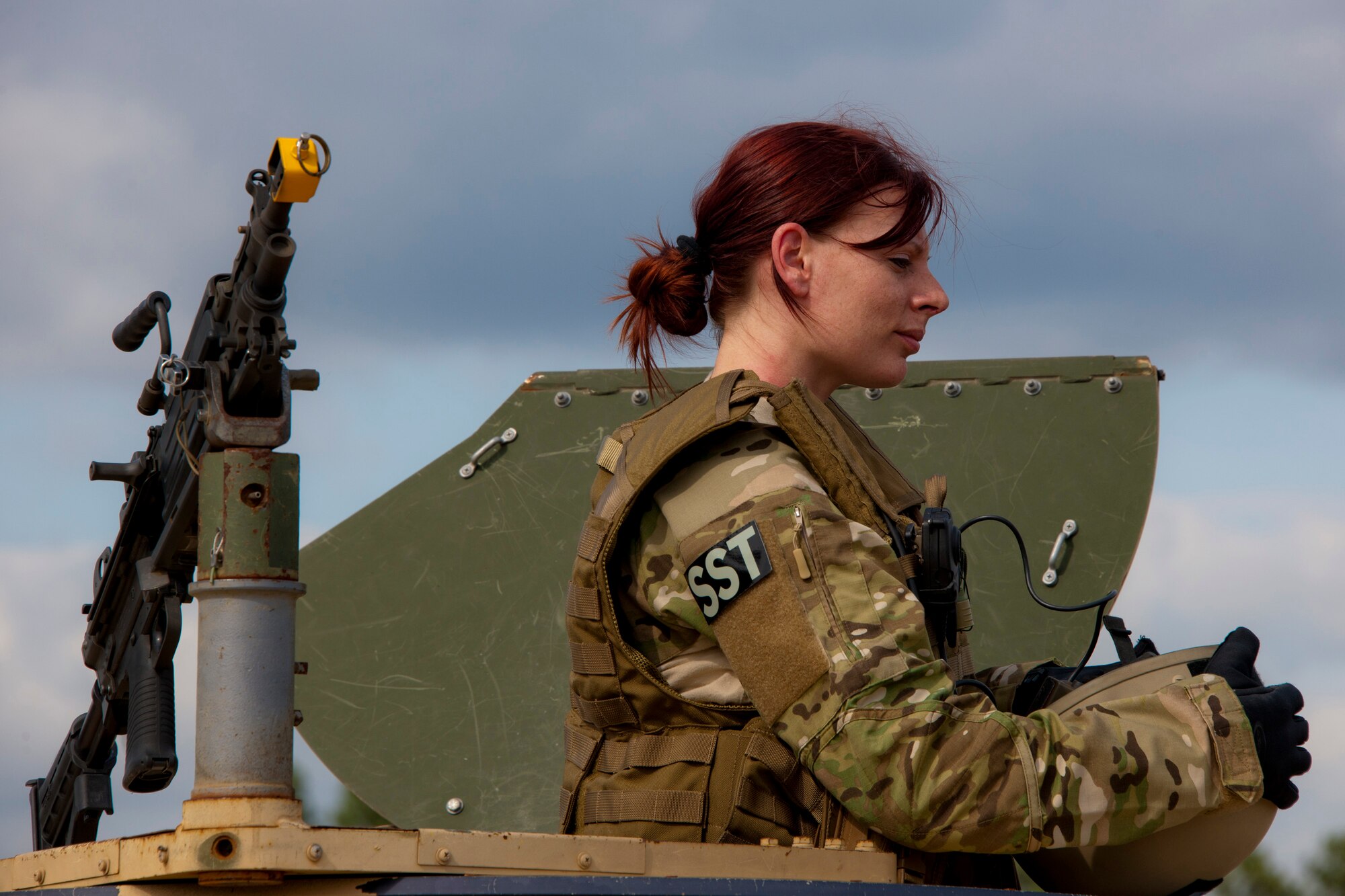 Senior Airman Gina Esparza, of the 919th Security Forces Squadron, rests after keeping the perimeter secure from the top of a humvee during a prisoner recovery exercise Feb. 23 at Duke Field, Fla.  Airmen executed the procedure for Brig. Gen. William Binger, the 10th Air Force commander, during his visit to the base.  Binger rode with the 919th Airmen during the assault on the compound and entered the building with the fire team.  He was given a first-hand view of the evidence collection procedures performed throughout the building after it was secured and the prisoner was recovered.  (U.S. Air Force photo/Tech. Sgt. Samuel King Jr.)