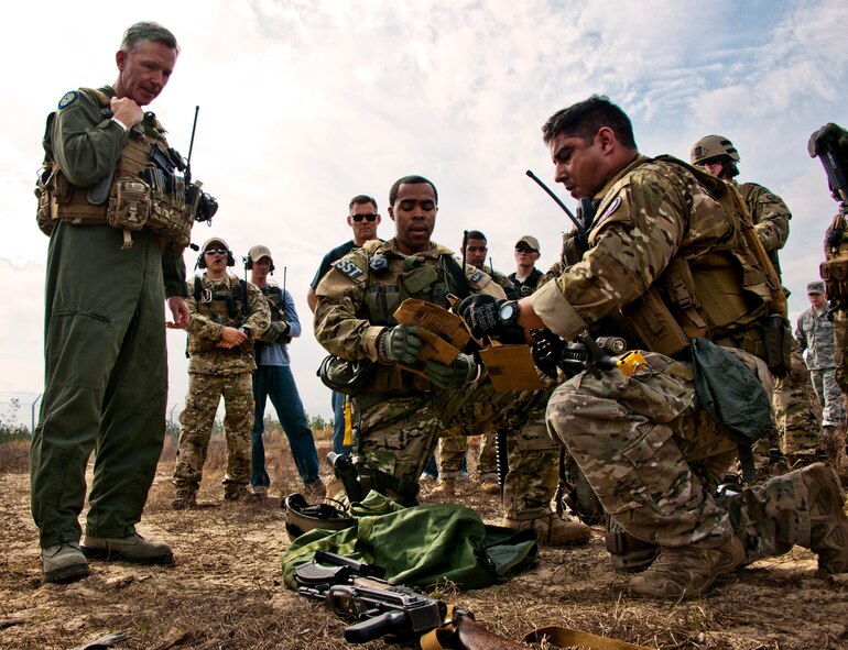 Senior Airmen John Flagg (middle) and Ramon Torres, of the 919th Security Forces Squadron, explain their evidence gathering procedures to Brig. Gen. William Binger, the 10th Air Force commander, after a prisoner recovery exercise Feb. 23, at Duke Field, Fla.  Binger rode with the 919th Airmen during the assault on the compound and entered the building with the fire team.  He was given a first-hand view of the evidence collection procedures performed throughout the building after it was secured and the prisoner was recovered.  (U.S. Air Force photo/Tech. Sgt. Samuel King Jr.)