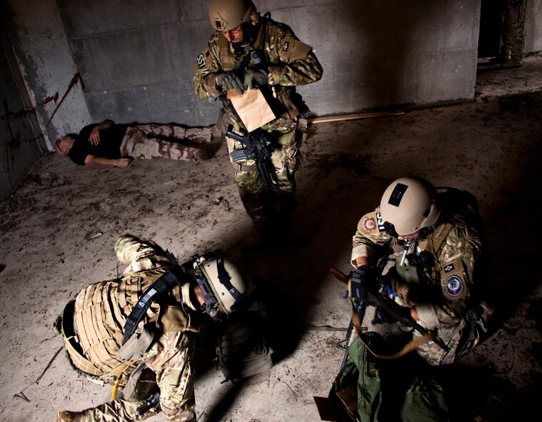 Airmen with the 919th Security Forces Squadron gather up their evidence to leave the building after a prisoner recovery exercise at Duke Field, Fla., Feb. 23.  Airmen executed the procedure for Brig. Gen. William Binger, the 10th Air Force commander, during his visit to the base.  Binger rode with the 919th Airmen during the assault on the compound and entered the building with the fire team.  He was given a first-hand view of the evidence collection procedures performed throughout the building after it was secured and the prisoner was recovered.  (U.S. Air Force photo/Tech. Sgt. Samuel King Jr.)