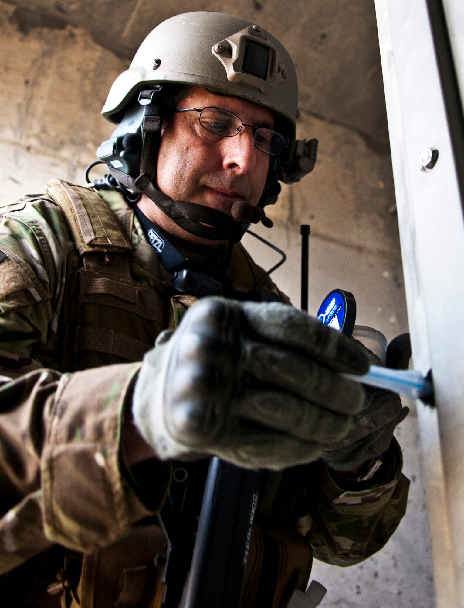 Tech. Sgt. Stephan Tterlikkis, of the 919th Security Forces Squadron, dusts an entry way for fingerprints after a prisoner recovery exercise at Duke Field, Fla., Feb. 23.  Airmen executed the procedure for Brig. Gen. William Binger, the 10th Air Force commander, during his visit to the base.  Binger rode with the 919th Airmen during the assault on the compound and entered the building with the fire team.  He was given a first-hand view of the evidence collection procedures performed throughout the building after it was secured and the prisoner was recovered.  (U.S. Air Force photo/Tech. Sgt. Samuel King Jr.)