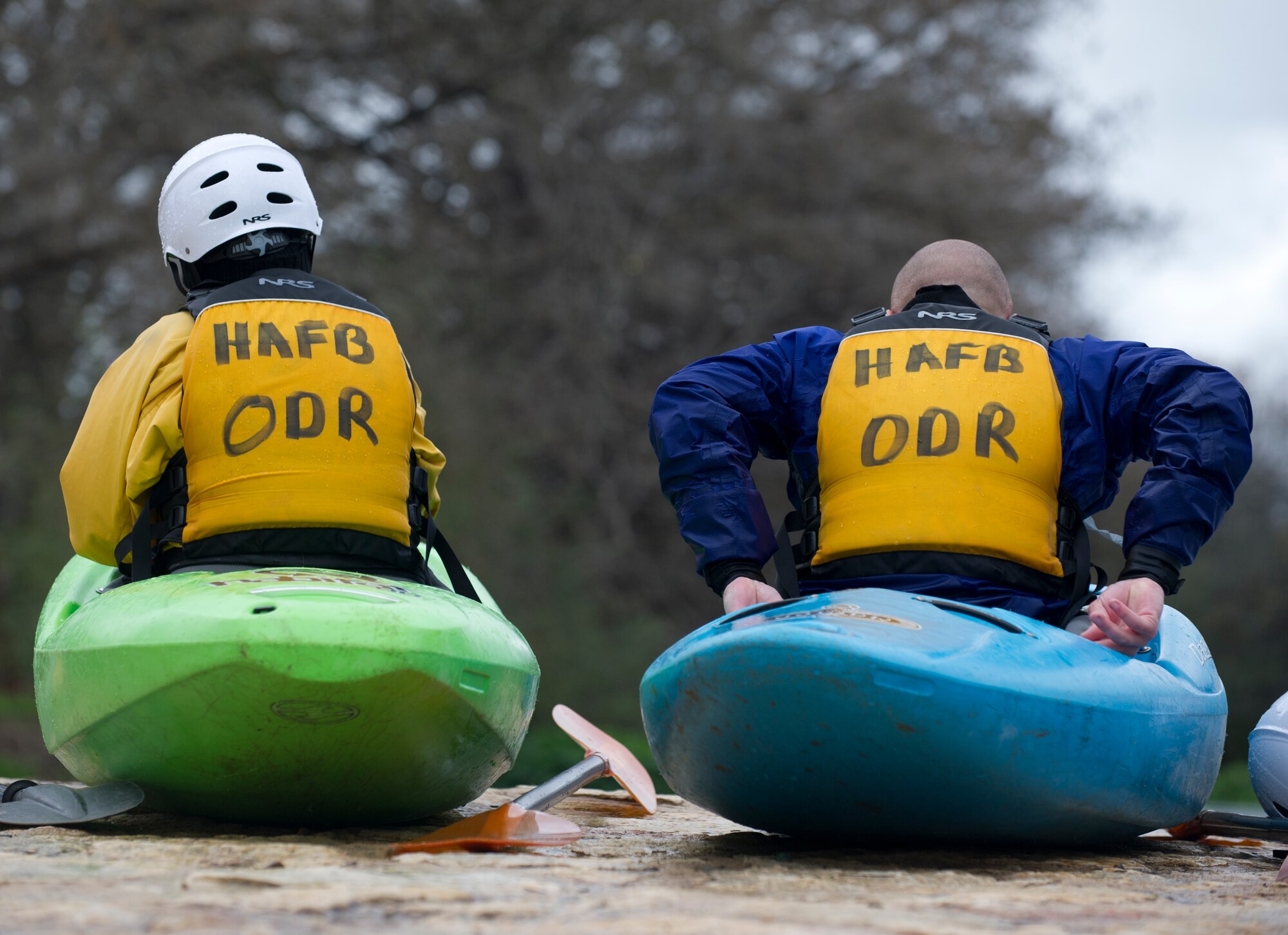 SAN MARCOS, Texas –- Amanda Gallagher, marketing director for the 49th Force Support Squadron, and U.S. Air Force Airman 1st Class Anthony Ward, 49th Wing public affairs, strap into their kayaks before preparing to shove off into the San Marcos River Feb. 19. The Airmen spouse and civilian were learning the basics of kayaking and white- water rapids in order to enable quick thinking and critical decision-making skills. As a part of the Holloman Outdoor Wingman Program, they also learned how to apply those same skills to everyday life. (U.S. Air Force photo by Airman 1st Class Daniel E. Liddicoet/Released)