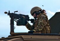 Senior Airman Gina Esparza, of the 919th Security Forces Squadron, fires at simulated enemies moving around the perimeter of the compound during a prisoner recovery exercise at Duke Field, Fla., Feb. 23.  Airmen executed the procedure for Brig. Gen. William Binger, the 10th Air Force commander, during his visit to the base.  Binger rode with the 919th Airmen during the assault on the compound and entered the building with the fire team.  He was given a first-hand view of the evidence collection procedures performed throughout the building after it was secured and the prisoner was recovered.  (U.S. Air Force photo/Tech. Sgt. Samuel King Jr.)