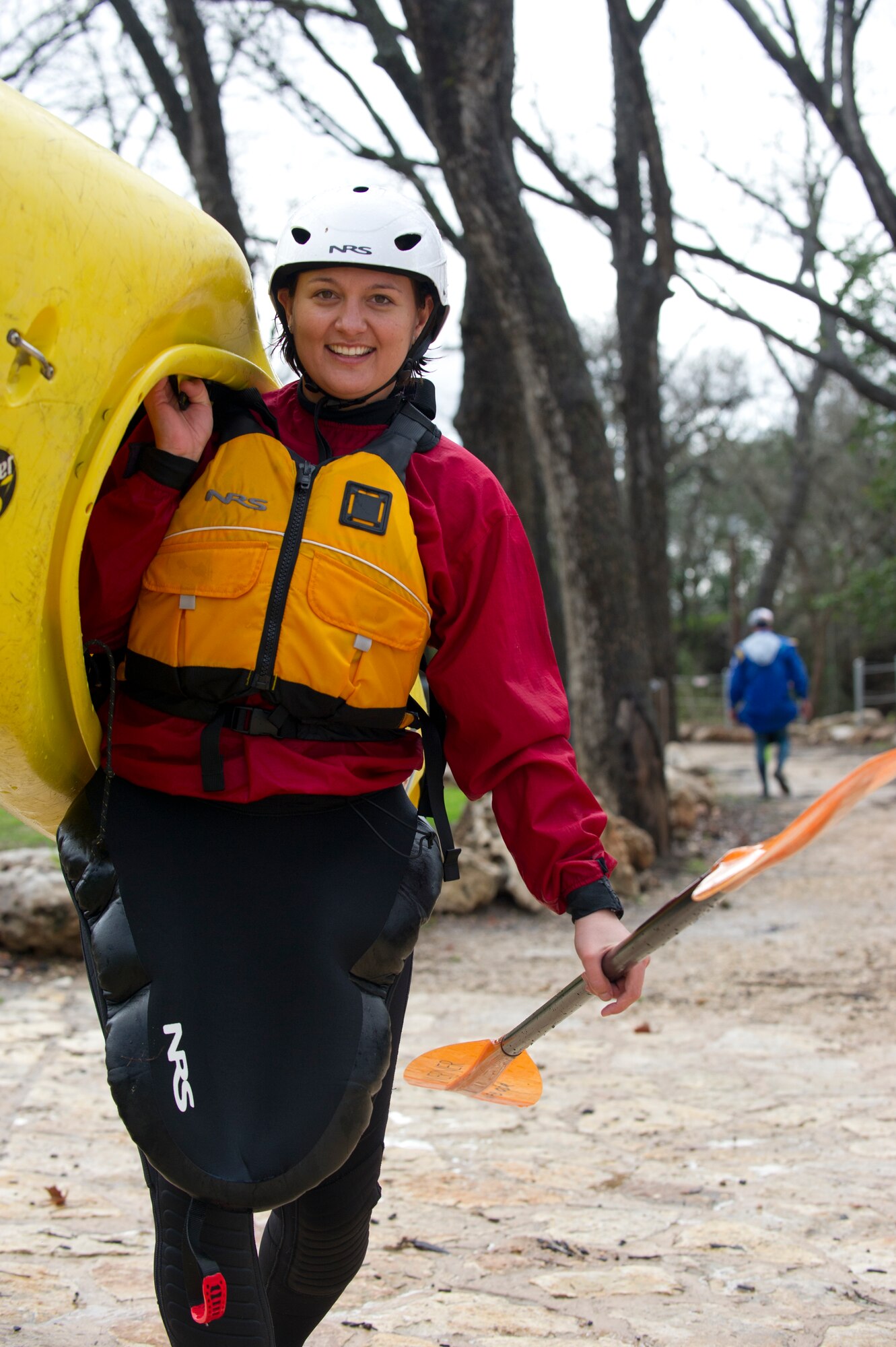 SAN MARCOS, Texas –- U.S. Air Force Staff Sgt. Jennifer Pemp, physical therapist with the 49th Medical Operations Squadron, carries her kayak out of the San Marcos River after a day of instruction and kayaking Feb. 19. Airmen a spouse and a civilian participating in the Holloman Outdoor Wingman Program came to San Marcos to gain a basic understanding of the principles of kayaking and to learn to apply the same critical thinking skills to everyday life. Each Airman, spouse and civilian walked away with a better understanding of both how to manage themselves on a white-water rapid and how to cope through the stress of work in a healthy way. (U.S. Air Force photo by Airman 1st Class Daniel E. Liddicoet/Released)