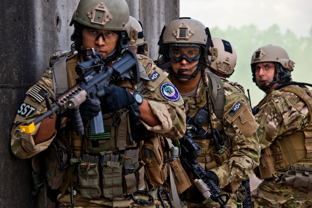 Staff Sgt. Gabriel Ortiz, Senior Airman Jarrod Barnes and Tech. Sgt. Stephan Tterlikkis, of the 919th Security Forces Squadron, prepare to enter the building during a prisoner recovery exercise at Duke Field, Fla., Feb. 23.  Security forces Airmen executed the procedure for Brig. Gen. William Binger, the 10th Air Force commander, during his visit to the base.  Binger rode with the 919th Airmen during the assault on the compound and entered the building with the fire team.  He was given a first-hand view of the evidence collection procedures performed throughout the building after it was secured and the prisoner was recovered.  (U.S. Air Force photo/Tech. Sgt. Samuel King Jr.)