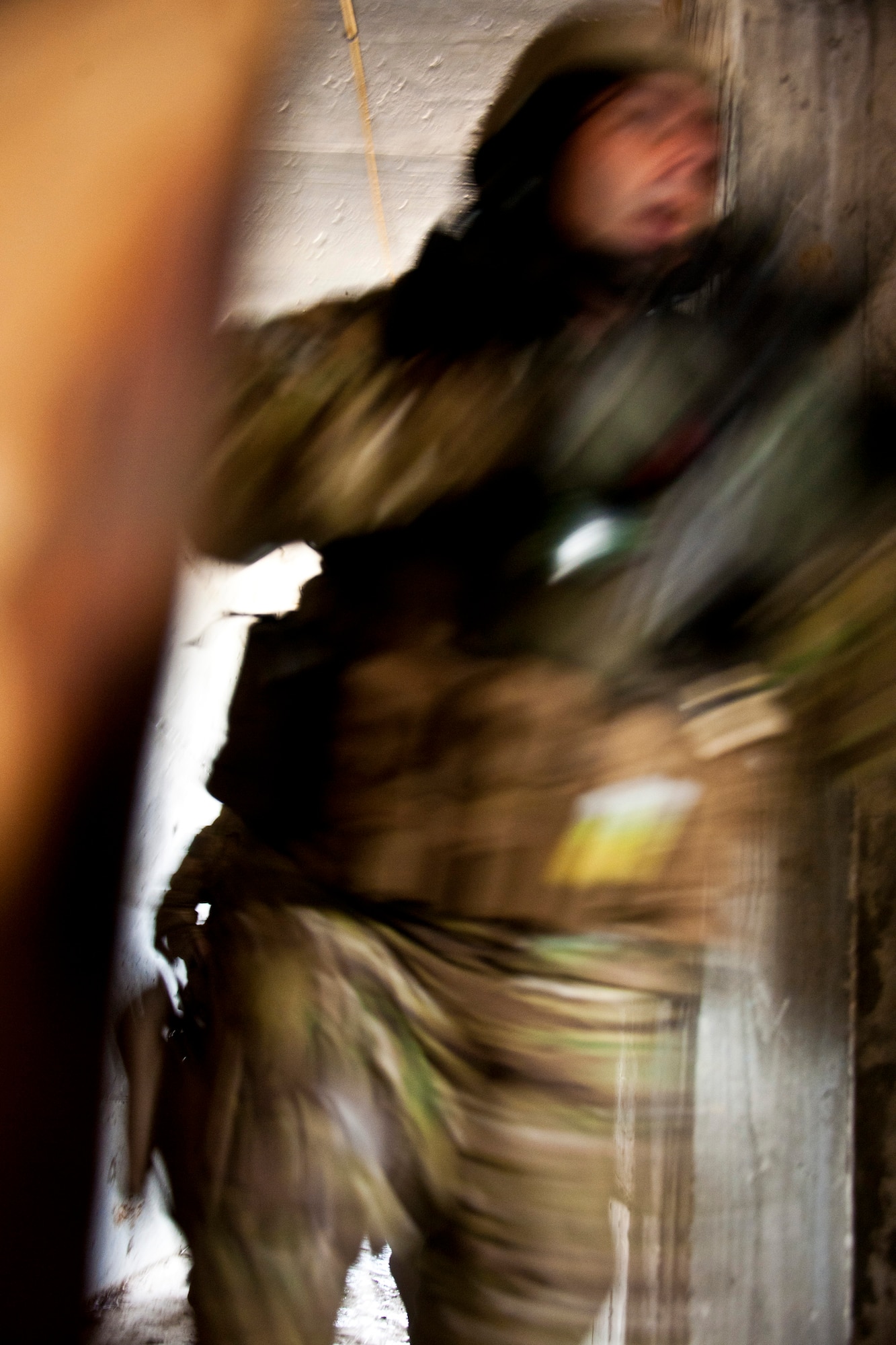 A 919th Security Forces Squadron Airman follows his fire team into a room during a prisoner recovery exercise at Duke Field, Fla., Feb. 23.  Airmen executed the procedure for Brig. Gen. William Binger, the 10th Air Force commander, during his visit to the base.  Binger rode with the 919th Airmen during the assault on the compound and entered the building with the fire team.  He was given a first-hand view of the evidence collection procedures performed throughout the building after it was secured and the prisoner was recovered.  (U.S. Air Force photo/Tech. Sgt. Samuel King Jr.)