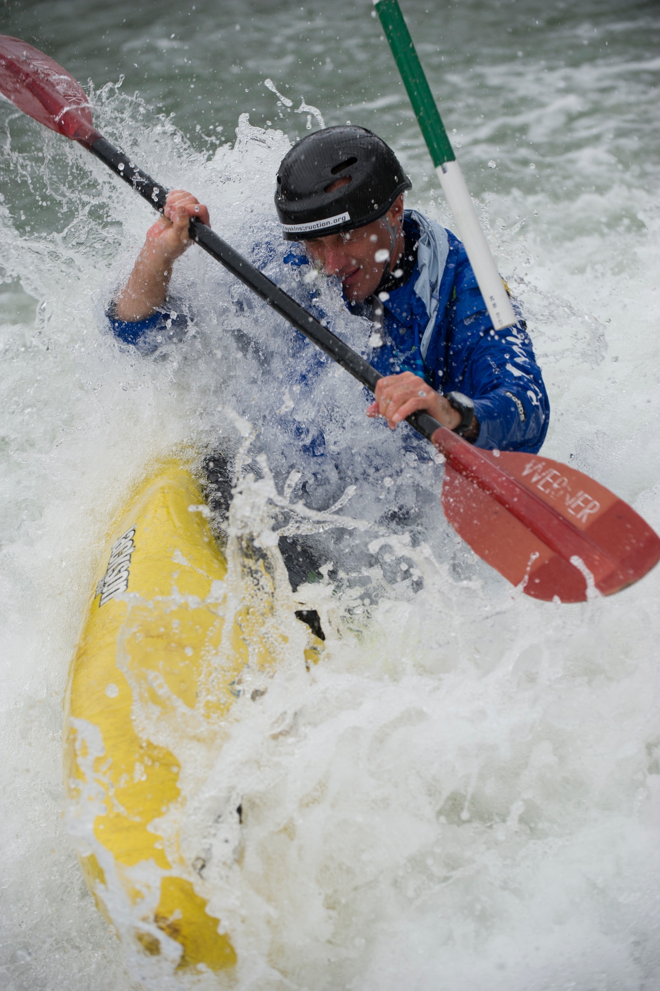 SAN MARCOS, Texas –- Ben Kvanli, former Olympian and current kayaking instructor with the Red River Racing Team, surfs through the rapids in his kayak here Feb. 19. Kvanli spent nearly his whole life kayaking in the Texas region, and competed in the white-water slalom event at the 1996 Atlanta Olympics. He now manages the Red River Racing Team and supports a group of instructors that aims to help developing paddlers in the sport.  Kvanli was the primary instructor guiding Airmen a spouse and a civilian from the Holloman Outdoor Wingman Program on their kayaking trip to San Marcos. (U.S. Air Force photo by Airman 1st Class Daniel E. Liddicoet/Released)