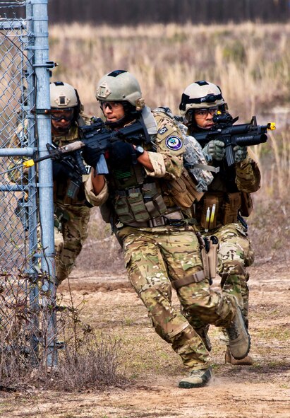 Staff Sgt. Gabriel Ortiz leads Senior Airman John Flagg and other 919th Security Forces Squadron Airmen into a compound during a prisoner recovery exercise at Duke Field, Fla., Feb. 23.  Security forces Airmen executed the procedure for Brig. Gen. William Binger, the 10th Air Force commander, during his visit to the base.  Binger rode with the 919th Airmen during the assault on the compound and entered the building with the fire team.  He was given a first-hand view of the evidence collection procedures performed throughout the building after it was secured and the prisoner was recovered.  (U.S. Air Force photo/Tech. Sgt. Samuel King Jr.)