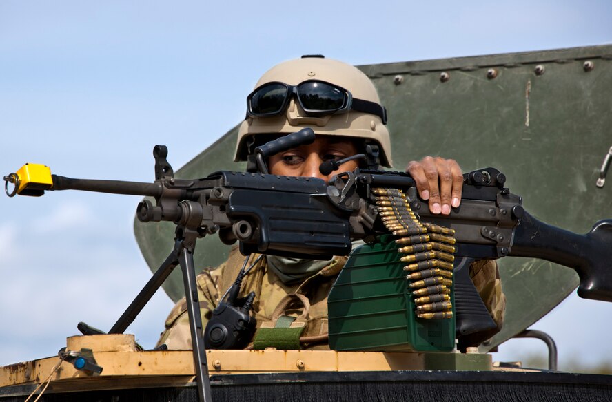 Senior Airman Adrienne Barron, of the 919th Security Forces Squadron, secures her M-249 before leaving for a mission at Duke Field, Fla., Feb. 23.  Security forces Airmen performed a prisoner recovery exercise for Brig. Gen. William Binger, the 10th Air Force commander, during his visit to the base.  Binger rode with the 919th Airmen during the assault on the compound and entered the building with the fire team.  He was given a first-hand view of the evidence collection procedures performed throughout the building after it was secured and the prisoner was recovered.  (U.S. Air Force photo/Samuel King Jr.)