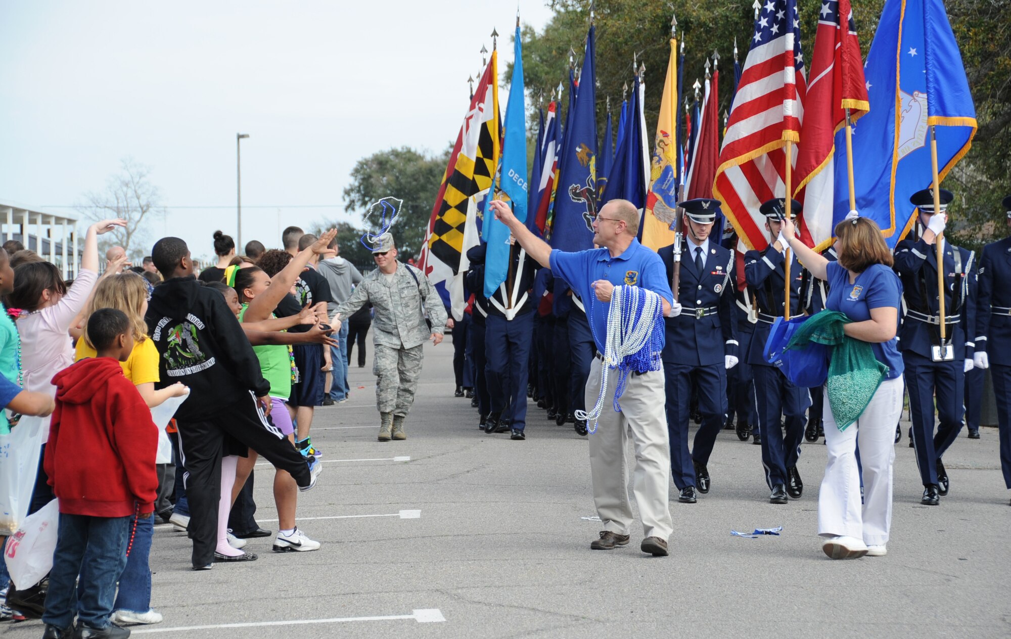 Keri and Brig. Gen. Andrew  Mueller, 81st Training Wing commander, Keesler Air Force Base, Miss., served as Grand Marshalls for the Jeff Davis Elementary School Mardi Gras parade in Biloxi, Miss., Feb. 17, 2012.  They led the parade and tossed beads as the Keesler Honor Guard and Airmen from the 81st Training Group carrying the 50 state flags followed.  (U.S. Air Force photo by Kemberly Groue)