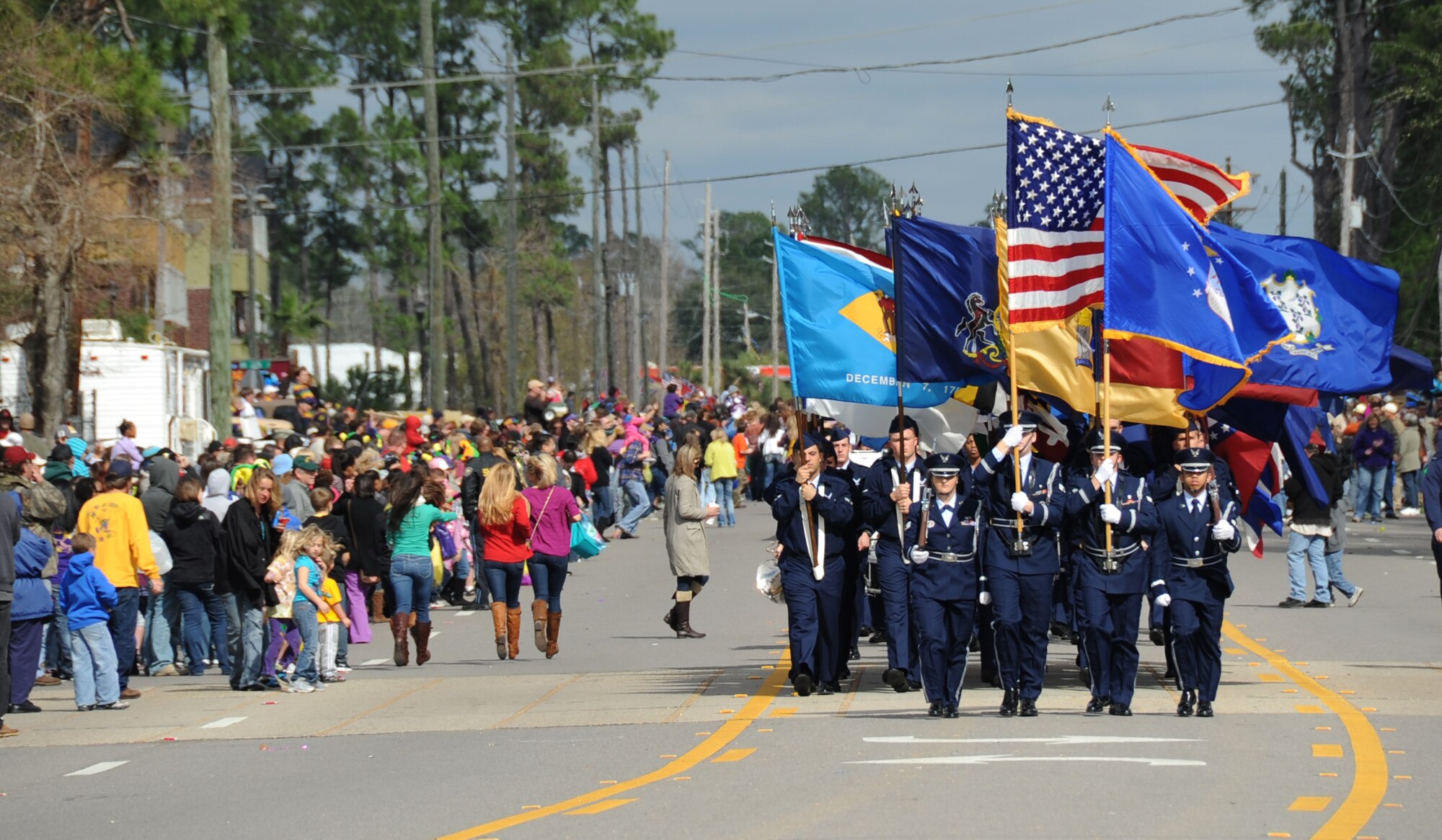 The Keesler Air Force Base Honor Guard and Airmen carrying the 50 state flags lead the D’Iberville, Miss., Mardi Gras parade Feb. 19, 2012.  Leadership from the 81st Training Wing also participated in the festivities.  (U.S. Air Force photo by Kemberly Groue)