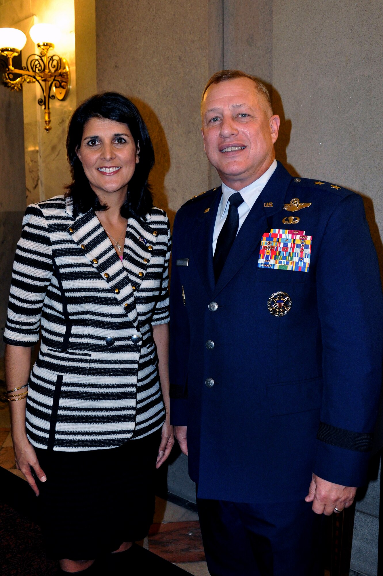 U.S. Air Force Maj. Gen. Lawrence Wells, 9th Air Force commander, (left), poses for a photo with S.C. Gov. Nikki Haley, in between sessions during his attendance at the Sumter Legislative Day 2012, Feb. 22, at the S.C. State House, Columbia, S.C. Wells discussed Shaw's positive effect on the economy. (U.S. Air Force photo by 1st Lt. Ann Blodzinski/Released) 

