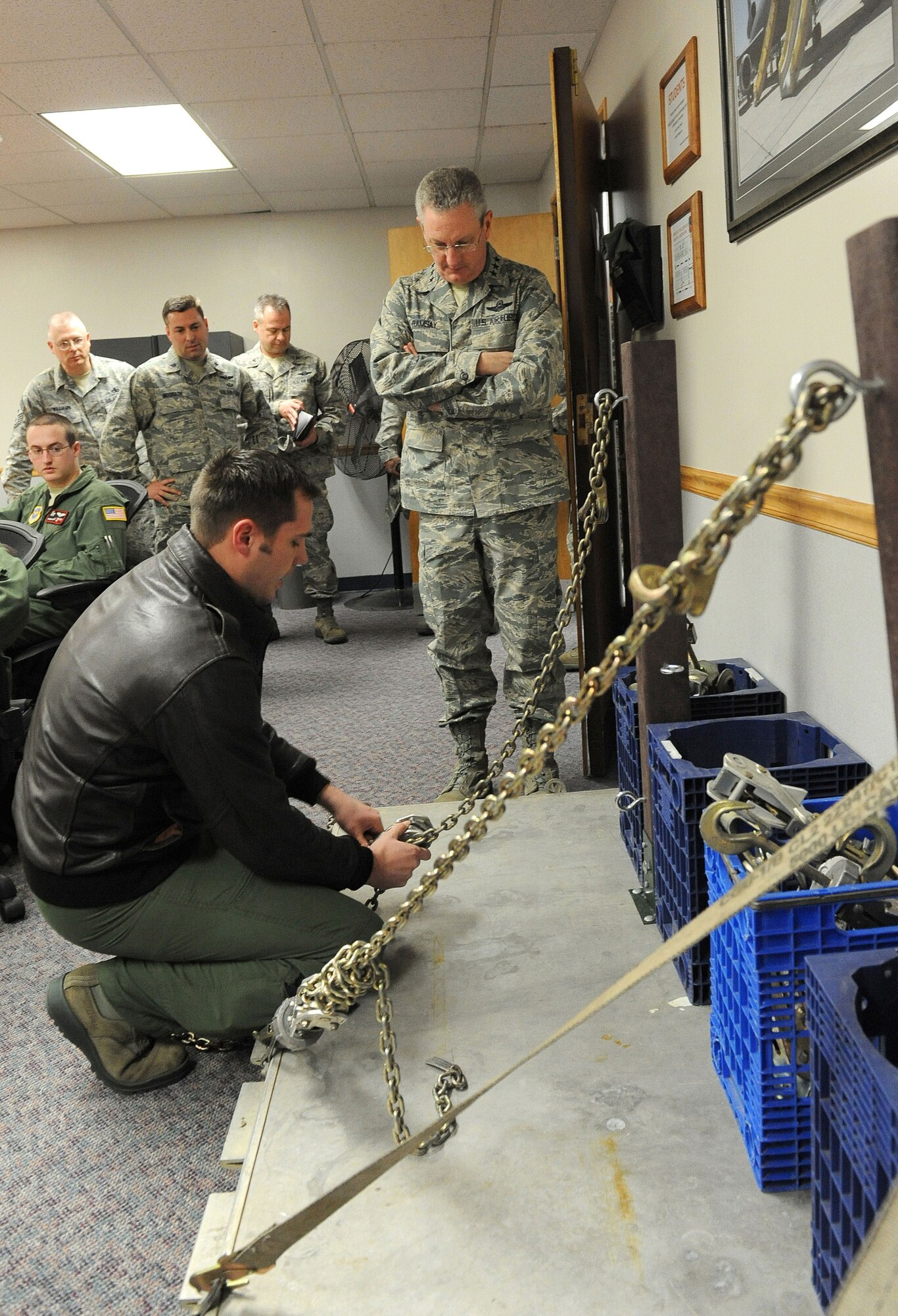 Staff Sgt. Kenneth Essick, 305th Operations Support Squadron, briefs Lt. Gen. Mark Ramsay, 18th Air Force commander, during the general's visit here Feb. 15 and 16. Essick explained the cargo-handling training device he designed and built to enhance KC-10 Extender boom operator training. This device, which models what is found on the KC-10, enables Airmen to receive hands-on training away from the aircraft. The training, which can now be conducted in a classroom, minimizes ground time for the aircraft thus effectively increasing mission time. (U.S. Air Force photo by Russ Meseroll/Released)
