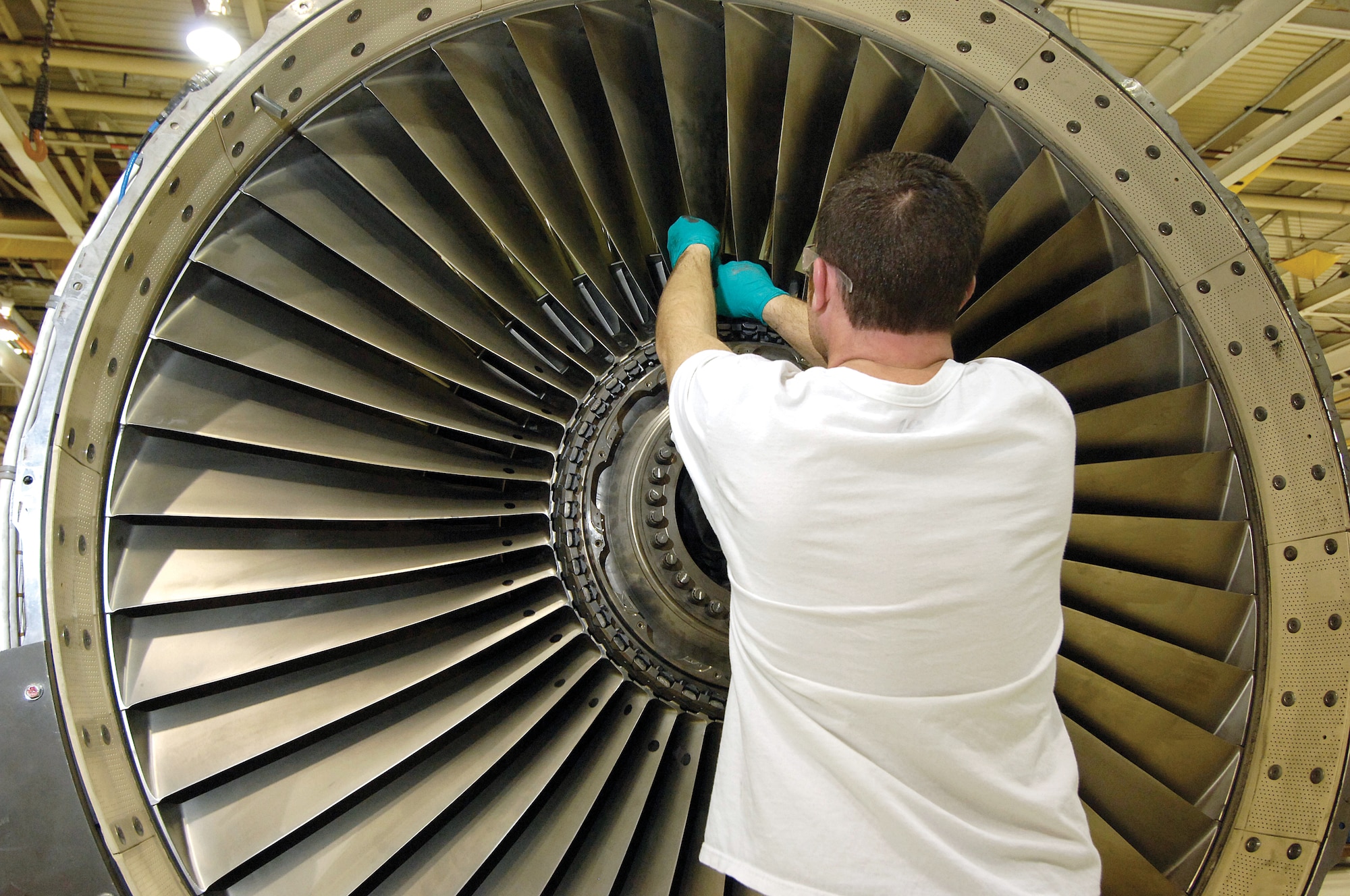 Richard Rook, a jet engine mechanic with the 546th Propulsion Maintenance Squadron, inserts a fan blade into an overhauled F108 fan frame major module. Tinker AFB recently purchased 1,036 sets of used fan blades rather than new ones for F108 engines, saving the Air Force more than $36 million. More of the fan blades are scheduled to be purchased over the next two years, for an additional estimated cost avoidance of another $34 million.