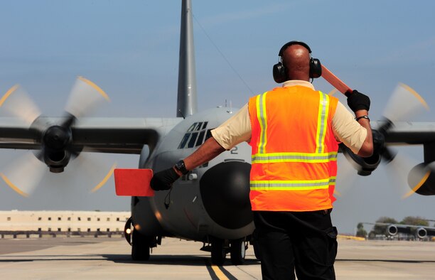 Rodney Pate, a Transit Alert employee with the 6th Aircraft Maintenance Squadron, marshalls in a Spanish C-130, Feb. 23, 2012, at MacDill Air Force Base, Fla. MacDill hosted two Spanish C-130 aircraft dispatched by the Spanish government to retrieve Spanish coins that were lost at sea in the 19th century. (U.S. Air Force photo/Airman Basic David Tracy)