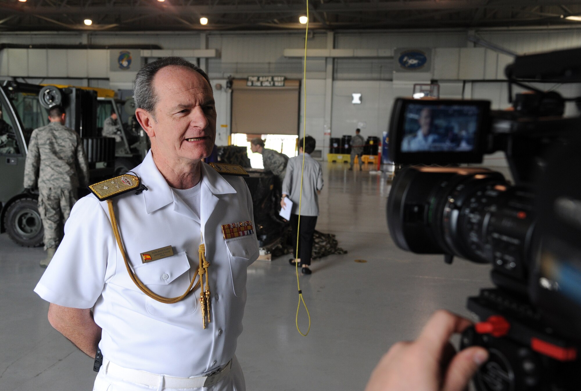 Spanish Navy Rear Adm. Javier Romero, Defense Attaché, gives an interview, at MacDill Air Force Base Fla., Feb. 23, 2012. Romero is escorting half of one billion dollars of Spanish coins, which were lost at sea in the 19th century and unearthed three years ago, back to Spain.  (U. S. Air Force photo by Airman Basic David Tracy)