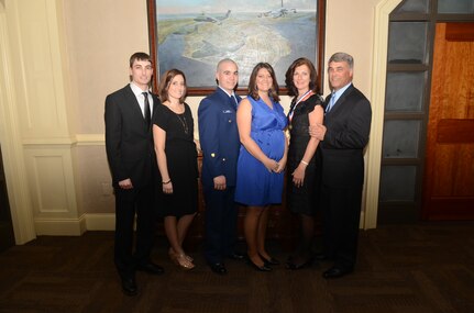 Kathy Knichel and her family pose for a photo after she was made an honorary chief master sergeant at the Chief's Recognition Ceremony at Joint Base Charleston - Air Base Club Feb. 4. (Left to right) Knichel's son Brian Knichel and his wife Emily Knichel, her son-in-law Fred Lacier and daughter Amie Lacier, Mrs. Knichel and her husband Mike. Knichel is the 628th Air Base Wing protocol officer. 