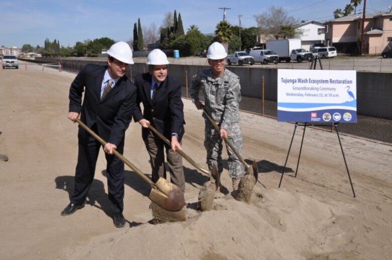 LOS ANGELES, Calif. — Mark Pestrella, Los Angeles County Public Works Deputy Director, Zev Yaroslavsky, Los Angeles County Supervisor, and Col. Mark Toy, U.S. Army Corps of Engineers Los Angeles district commander (left to right), ceremonially turn dirt Feb. 22 for the start of the $7 million Tujunga Wash Ecosystem Restoration project that will extend greening along the sides of a 3/4-mile stretch of concrete channel in the San Fernando Valley that carries runoff from Hansen Dam to the Los Angeles River.