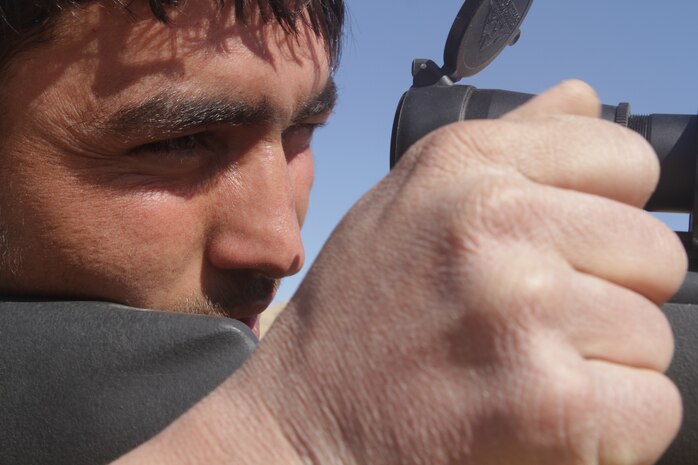 Afghan National Army Sgt. Dunya Gul, a squad leader with 2nd Tolai, 3rd Kandak, 2nd Brigade, 215th Corps, looks through his Leopold Mark 4 telescopic sight during advance marksmanship training here, Feb. 24. The top shooters from 3rd Kandak were selected to learn precision shooting from scout snipers with 2nd Battalion, 4th Marine Regiment. The Marines chose the best students to serve as marksmanship instructors and pass on their new skills to other Afghan soldiers.