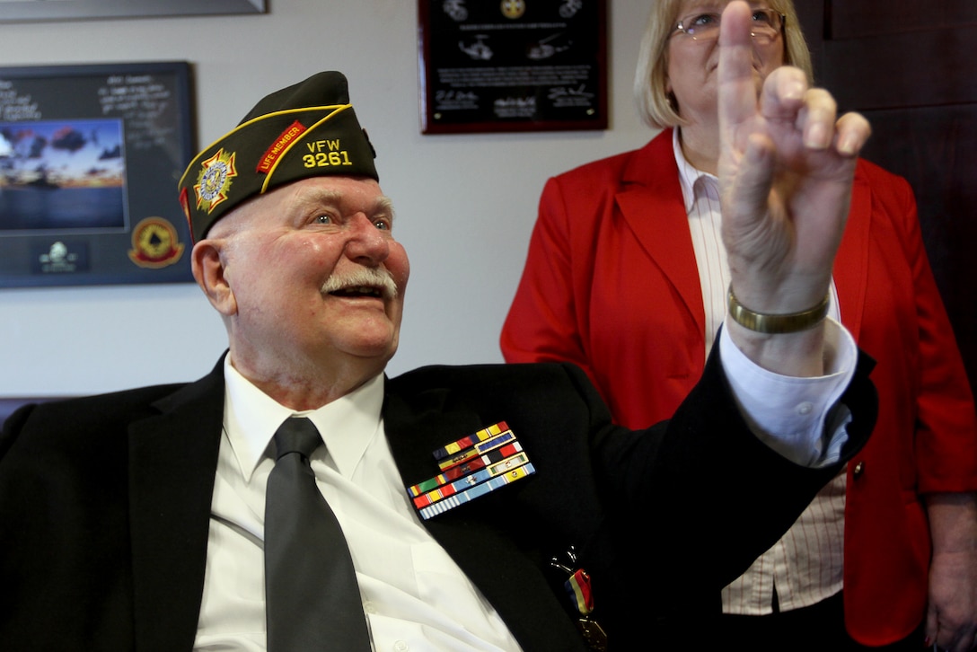 Charles P. Barrett, Jr., shares personal stories with his children and Marines in attendance after his Navy and Marine Corps Medal award ceremony at the Marine Corps Air Station Camp Pendleton, Feb. 24. Barrett risked his own personal safety to drive his burning fuel truck away from all aircrafts, personnel and munitions on May 13, 1951.