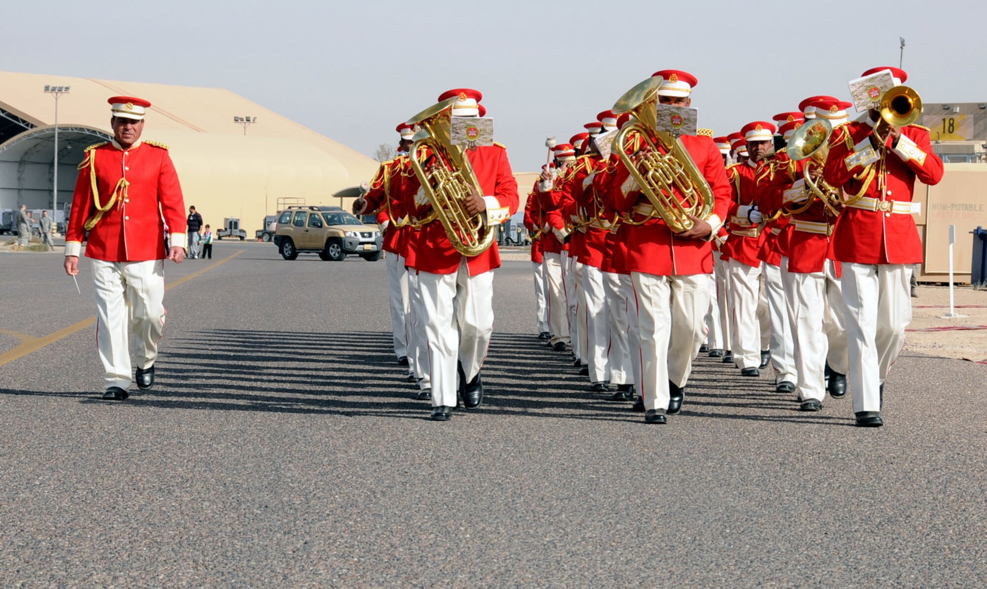 A host nation marching band performs at an undisclosed location, Southwest Asia, Feb. 23, 2012. The band was performing as part of an open house that displayed a large number of U.S. and host nation military respective aircraft, vehicles and cooperation to host nation military members and their families as well as fellow U.S. military members. (U.S. Air Force photo by Staff Sgt. James Lieth/Released)