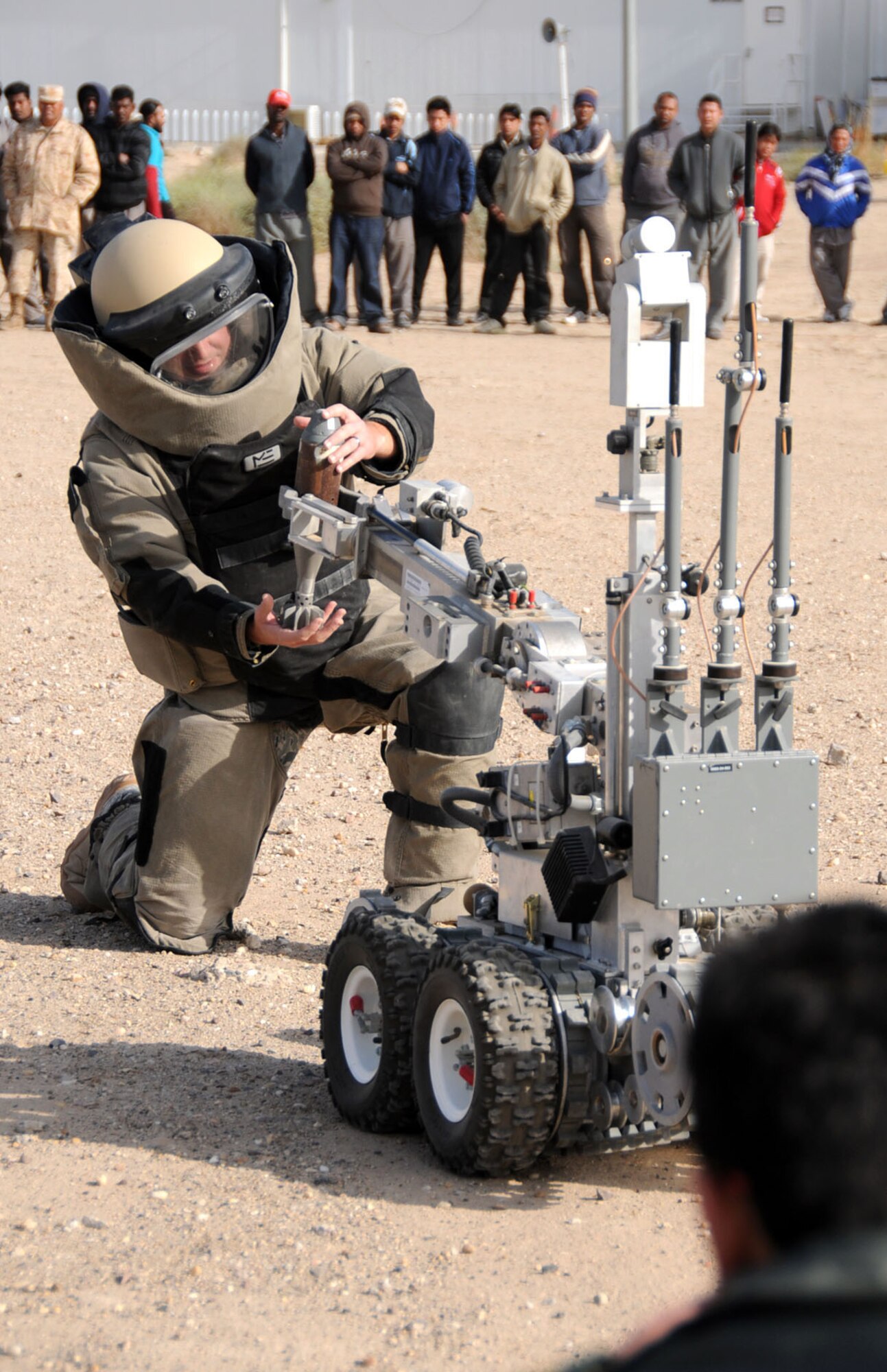 U.S. Air Force Staff Sgt. Benjamin Hiller, 386th Expeditionary Civil Engineering Squadron explosive ordnance technician and native of Millersburg, Ohio, displays capabilities of the Remotec F6A robot at an undisclosed location, Southwest Asia, Feb. 23, 2012. Hiller, deployed from the 802nd CES, Lackland Air Force Base, Texas, was part of a large number of U.S. and host nation military members that displayed their respective aircraft, vehicles and cooperation to host nation military members and their families as well as fellow U.S. military members during an open house. (U.S. Air Force photo by Staff Sgt. James Lieth/Released)