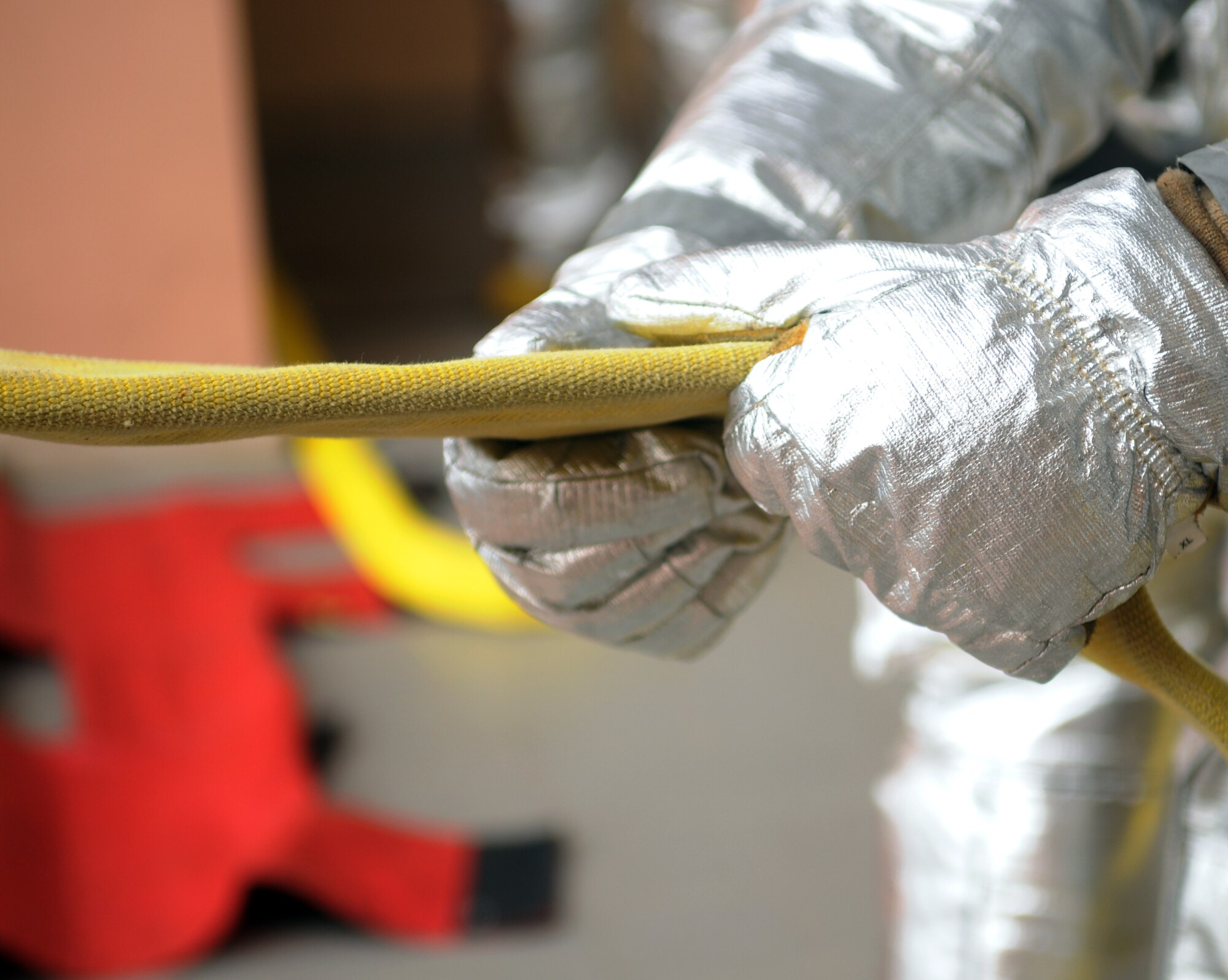 A 31st Civil Engineer Squadron firefighter, pulls a water hose onto the second floor of a building Feb. 23 at Aviano Air Base, Italy. The “flying standpipe” is a training scenario that helps make it easier, faster and safer for firefighters to fight fires in big buildings. (U.S. Air Force photo/Airman 1st Class Jenay Randolph) 