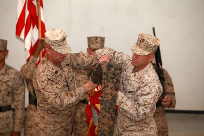 U.S. Marine Brig. Gen. Lewis A. Craparotta, commanding general, 2nd Marine Division (Forward) and Sgt. Maj. Joseph Shaw relinquish command during a transfer of authority ceremony, here, Feb. 25. The transfer of authority ceremony signifies the replacement of 2nd MarDiv (Fwd) by 1st Marine Division (Forward). (U.S. Marine Corps photo by Lance Cpl. Catie D. Edwards/Released)