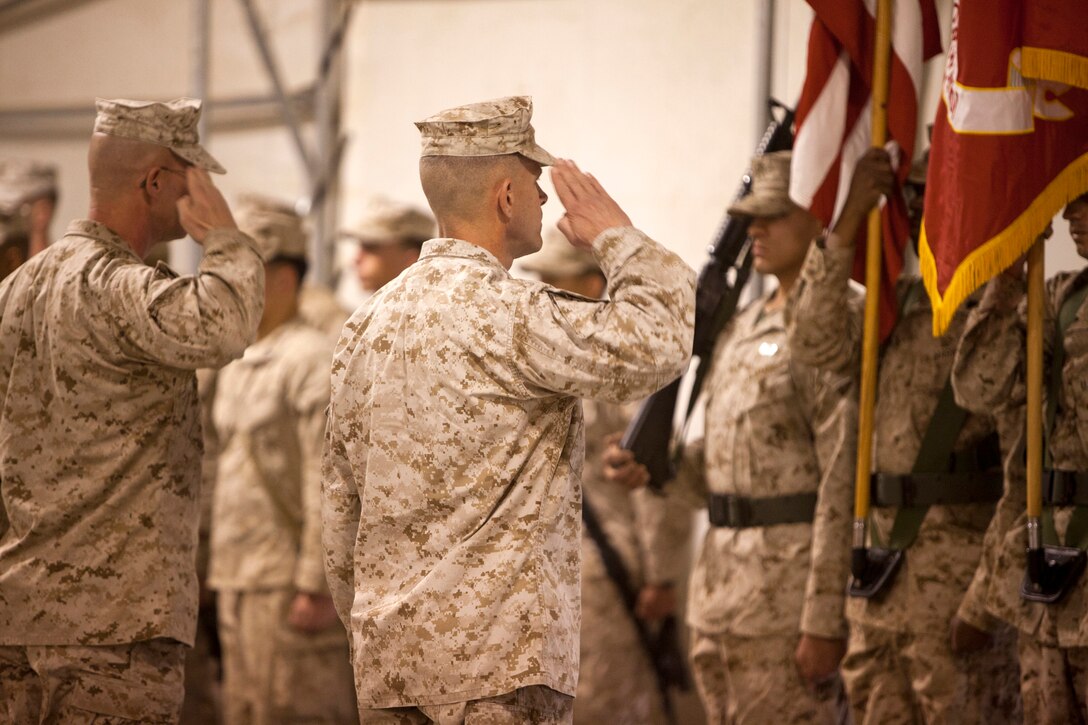 U.S. Marines Sgt. Maj. Joseph D. Shaw, 2nd Marine Division (Forward) Sergeant Major, left, and Brig. Gen. Lewis A. Craparotta, Commanding General, 2nd MarDiv (Fwd) salute the national and unit colors during a Transfer of Authority Ceremony, here, Feb. 25. The Transfer of Authority Ceremony signifies the relief of 2nd MarDiv (Fwd) by 1st MarDiv (Fwd). (U.S. Marine Corps Photo by: Sgt. Christopher R. Rye/ released)