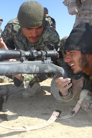 Afghan National Army Sgt. Dunya Gul, a squad leader with 2nd Tolai, 3rd Kandak, 2nd Brigade, 215th Corps, coaches ANA Pvt. Sefatala, a rifleman with Weapons Tolai, 3rd Kandak, during advanced marksmanship training here, Feb. 25. The top shooters from 3rd Kandak, 2nd Brigade, 215th Corps, were selected to learn precision shooting from scout snipers with 2nd Battalion, 4th Marine Regiment. The Marines chose the best students to serve as marksmanship instructors and pass on their new skills to other Afghan soldiers.