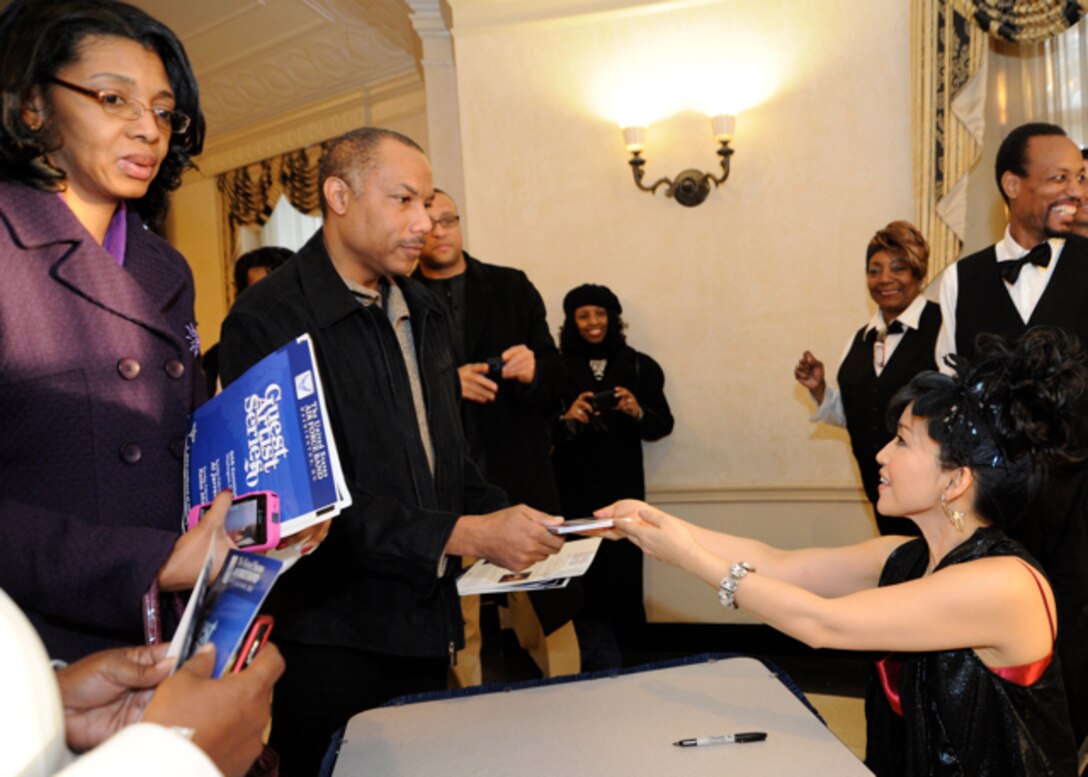 Keiko Matsui, contemporary jazz pianist, signs autographs after a performance with the United States Air Force Band at the Daughters of the American Revolution Constitution Hall in Washington, D.C., Feb. 26. (U.S. Air Force photo/Staff Sgt. Nichelle Anderson) 