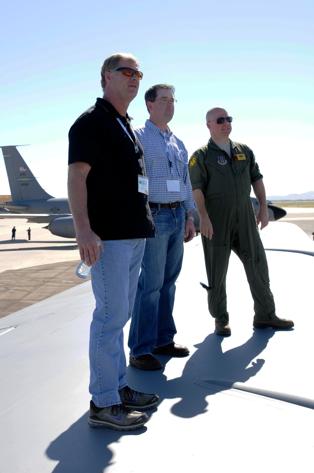 Maj. Ben Evans, right, a KC-135 Stratotanker pilot with the 507th Air Wing of the Air Force Reserves based at Tinker Air Force Base, Okla., stands on the wing of a KC-135 alongside civilian employers. The trio watch as A-10C Thunderbolt II "Warthogs" takeoff during a 188th Fighter Wing ESGR event at Davis-Monthan Air Force Base, Ariz. More than 40 local employers visited the Arkansas Air National Guard’s 188th Fighter Wing at Davis-Monthan AFB Feb. 22-23 to watch the Flying Razorbacks and their A-10s participate in Operation Snowbird, a combat rehearsal for the unit’s deployment to Afghanistan this summer in support of Operation Enduring Freedom. The event was part of an Employer Support for the Guard and Reserve (ESGR) trip. The objective was to give employers a better understanding of how vital the Guardsmen they employ are to the mission and how they each play a key role in the unit’s success. (National Guard photo by Maj. Heath Allen/188th Fighter Wing Public Affairs)