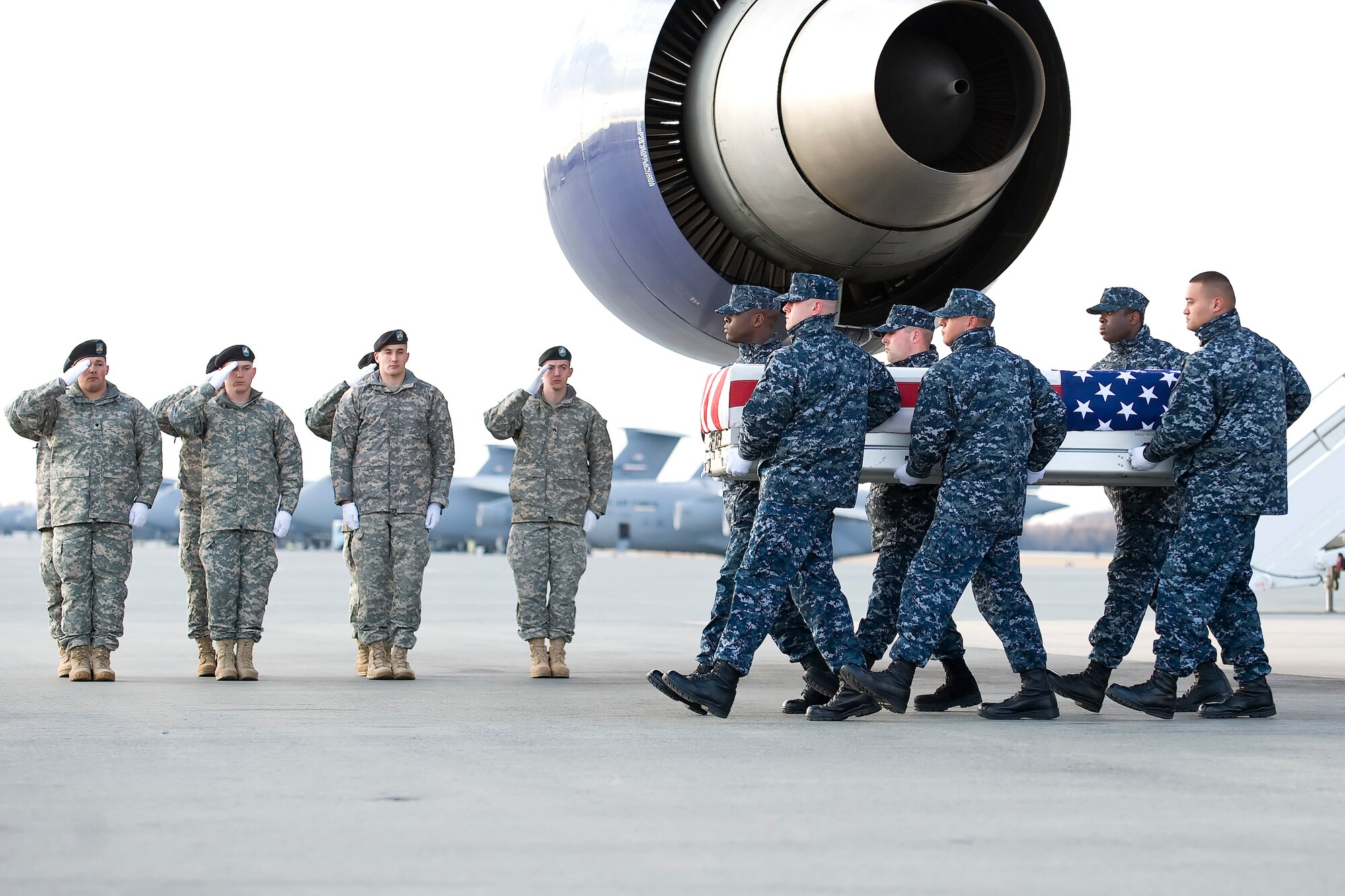 A U.S. Navy carry team transfers the remains of Navy Petty Officer 1st Class Paris S. Pough of Columbus, Ga., at Dover Air Force Base, Del., Feb. 25, 2012. Pough was assigned to the USS Carl Vinson (CVN 70), home-ported in San Diego, Calif. (U.S. Air Force photo/Adrian R. Rowan)
