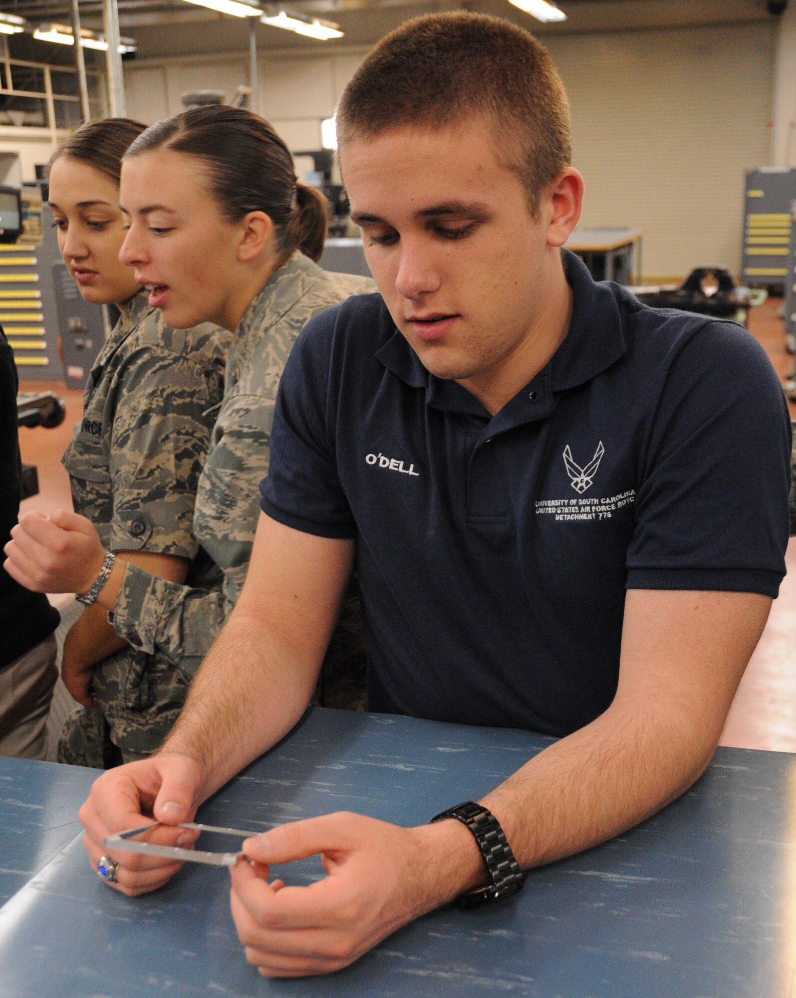 Cadets from the U.S. Air Force ROTC Detachment 775 examine custom-made aircraft parts Feb. 25, 2011 at Joint Base Charleston, S.C. The cadets watched as the parts were manufactured by computer numerical control systems at Joint Base Charleston, and they learned how metals technology designs and fabricates multiple parts for the day-to –day operations of the base. The cadets are students at the University of South Carolina. (U.S. Air Force photo/Staff Sgt. Shane Ellis)
