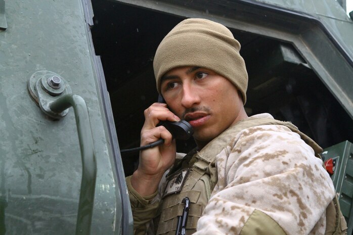 Sgt. Ricardo A. Monge, a launcher chief with 3rd Platoon, Tango Battery, 5th Battalion, 11th Marine Regiment, receives information from the fire direction center during a dry-fire drill for the High Mobility Artillery Rocket System here, Feb. 26. Monge, a 24-year-old native of Los Angeles, leads a three-man launcher team in daily drills to increase their response time to support requests. The HIMARS allows the Marines to support fire missions within minutes and deliver precision fire within one meter of the target location.