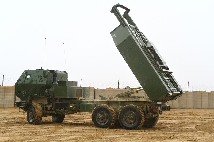 An M124 vehicle raises a rocket launcher pod during a dry-fire drill here, Feb. 26. The truck and launcher comprise the High Mobility Artillery Rocket System. The HIMARS allows the Marines to support fire missions within minutes and deliver precision fire within one meter of the target location.